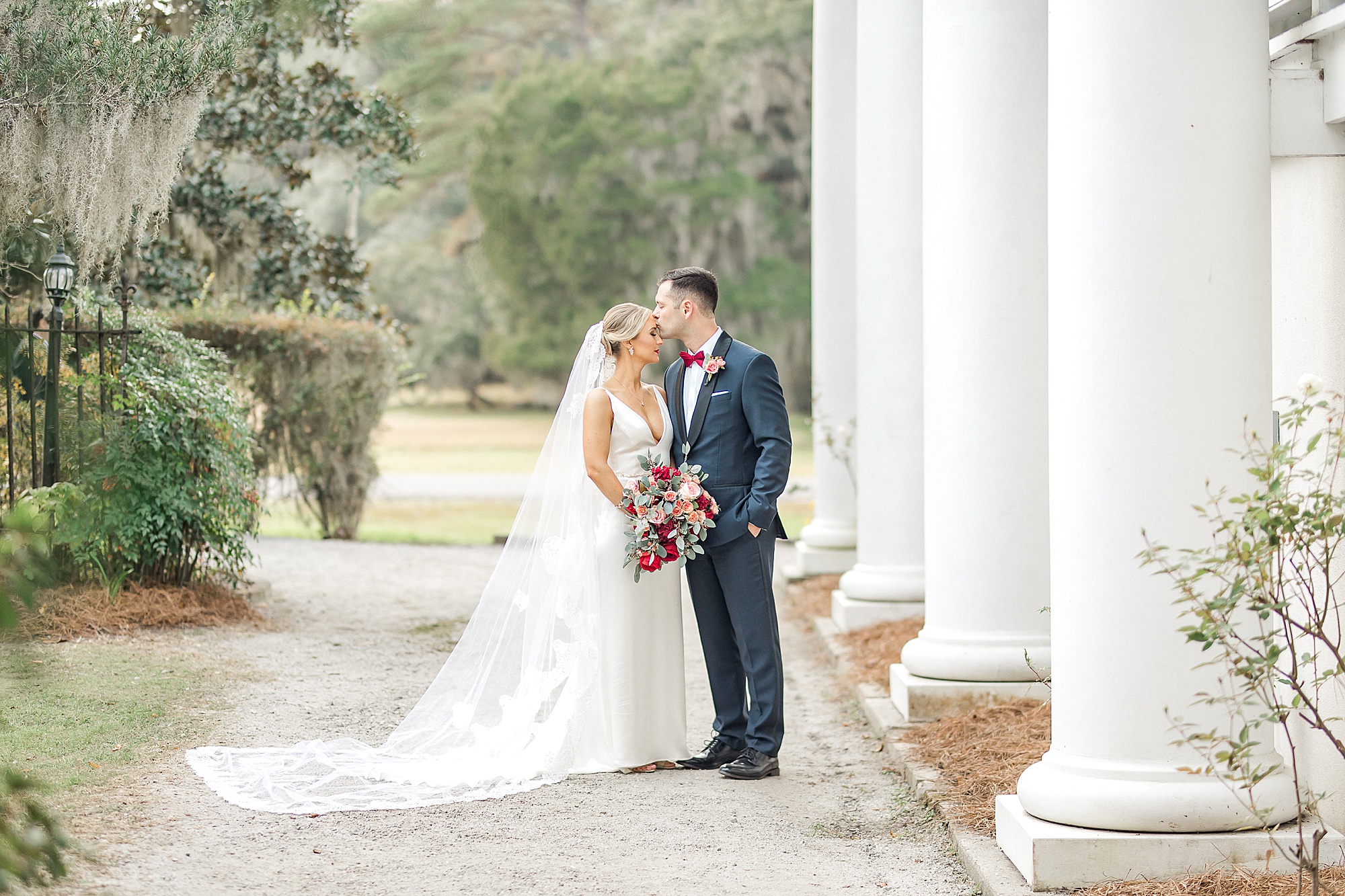 couple kiss outside Magnolia Plantation and Gardens wedding venue