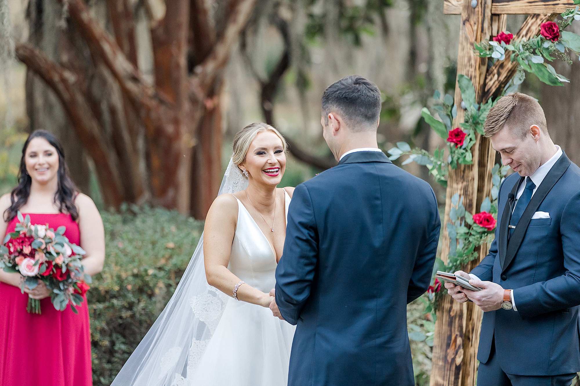 bride laughs at the alter with her groom
