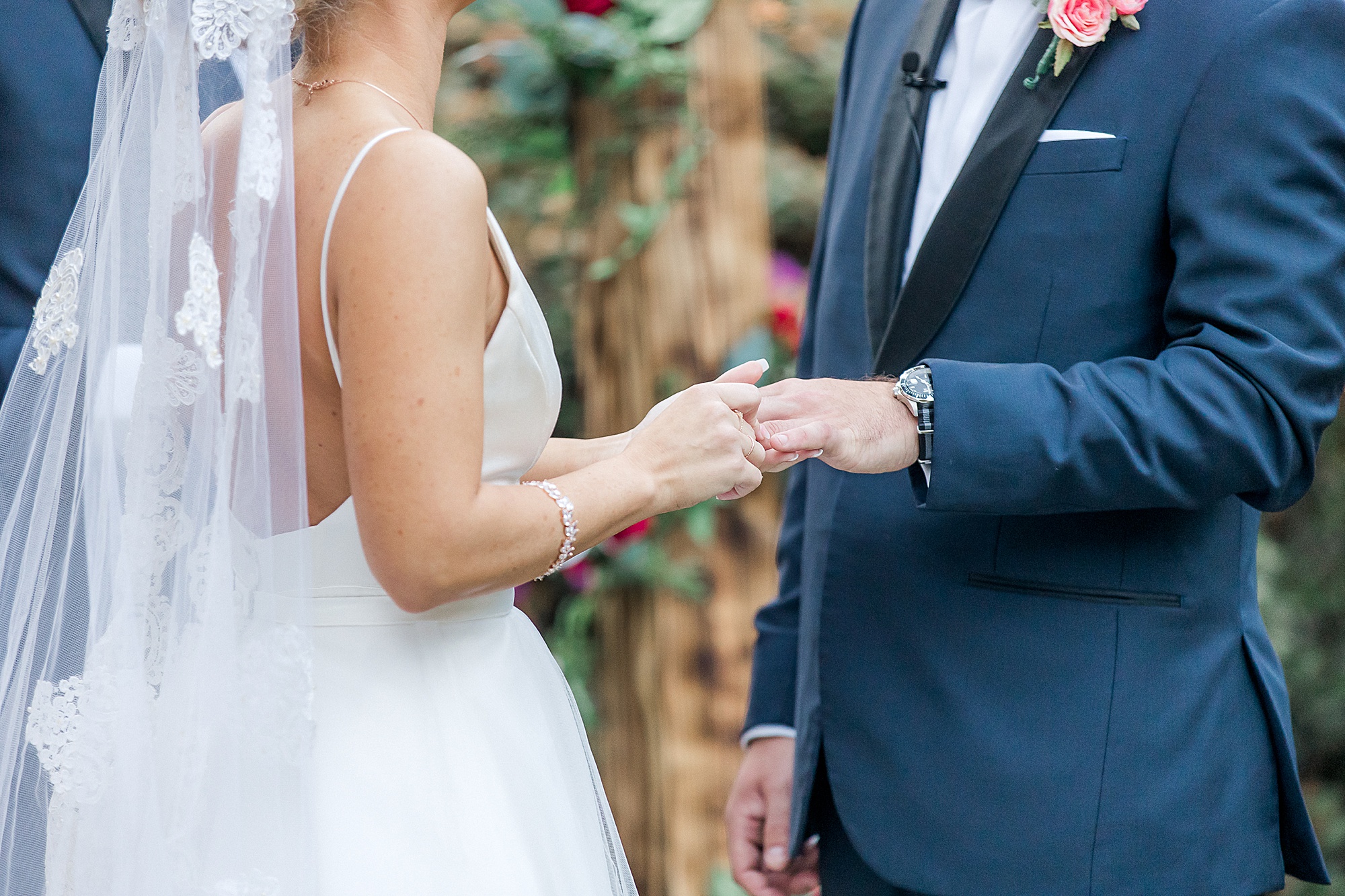 groom and bride exchange wedding rings