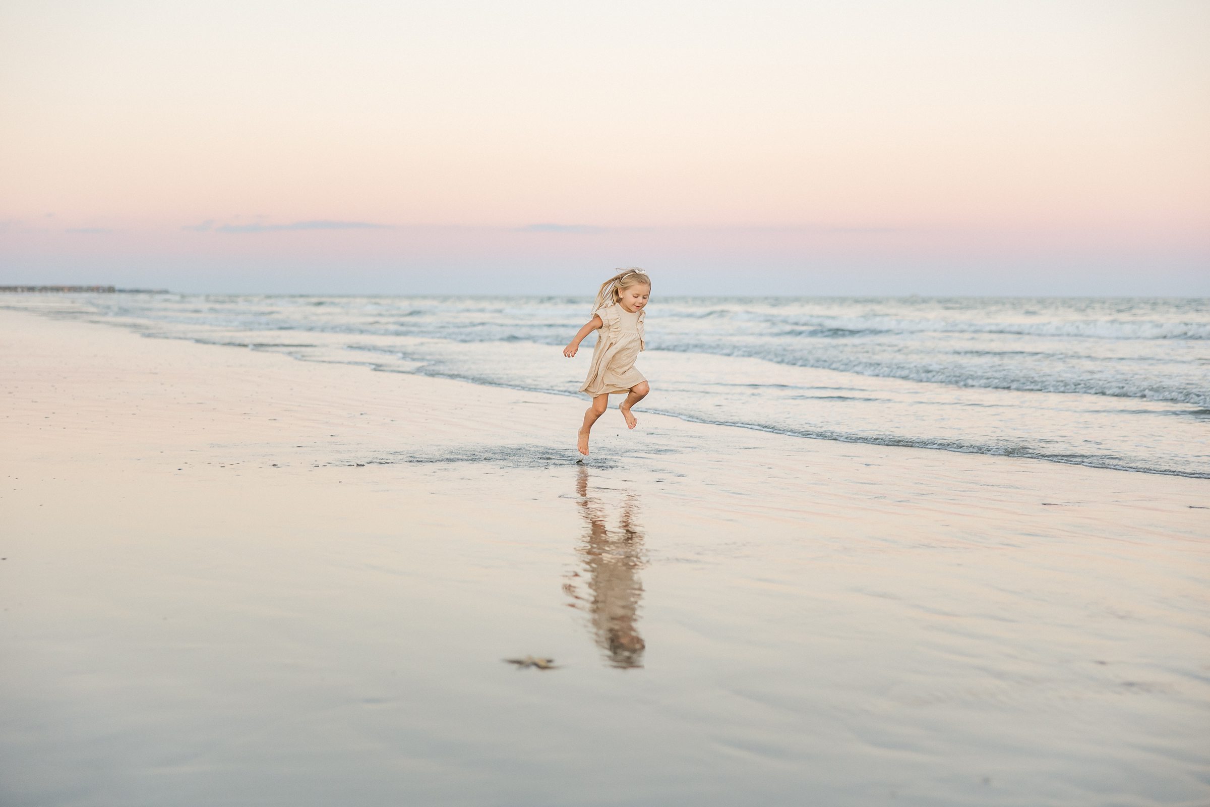 young girl runs on beach