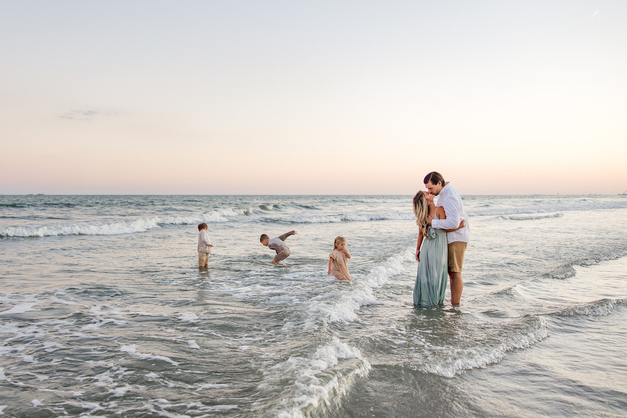 family plays in ocean