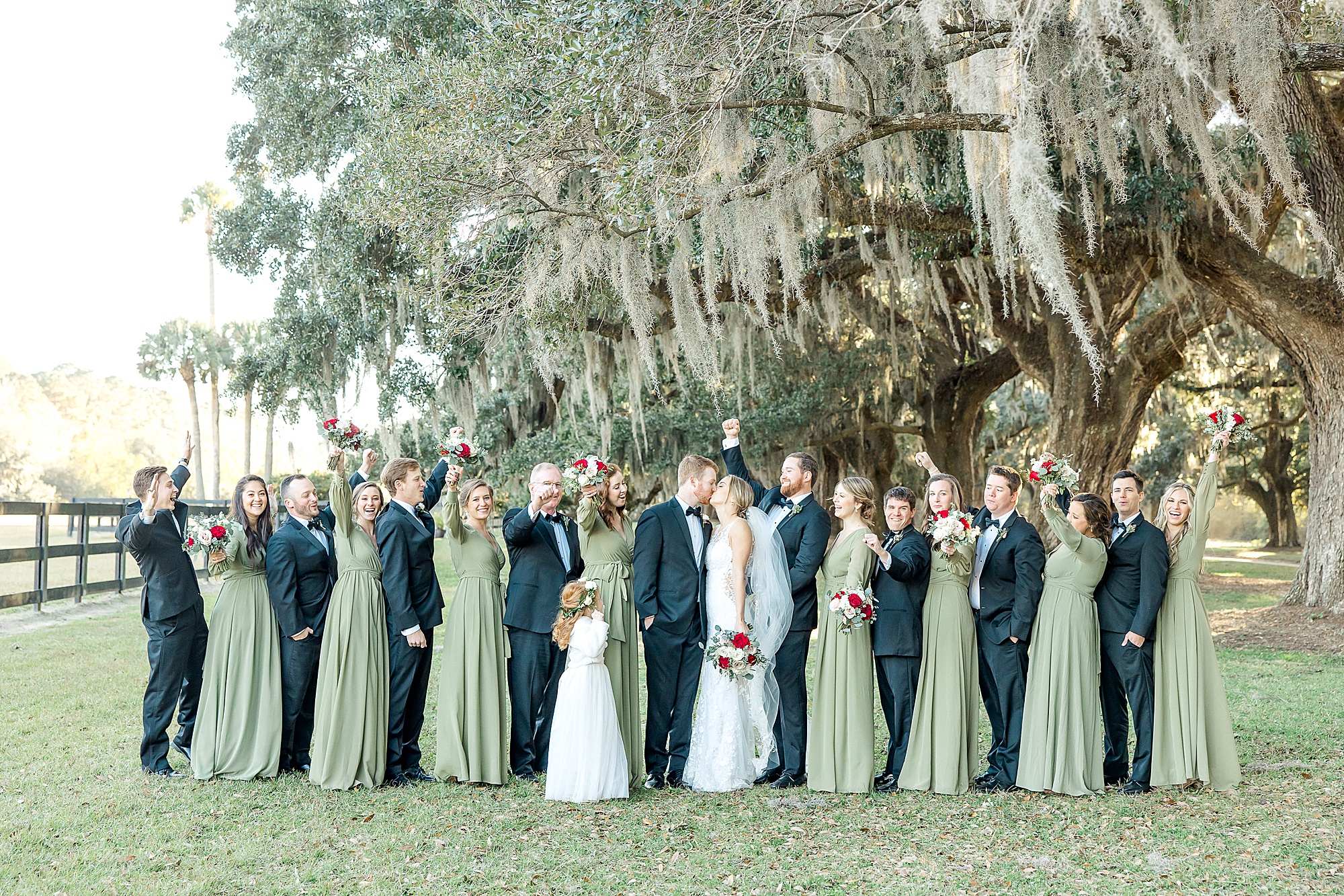 bridal party surrounds bride and groom before wedding ceremony
