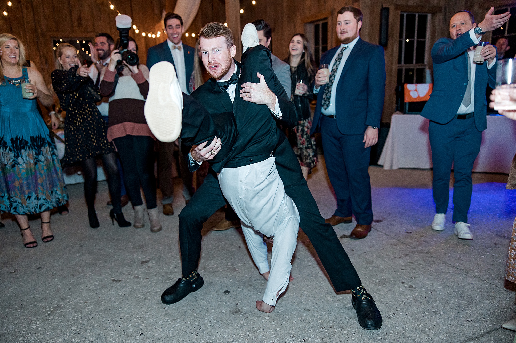 groom and groomsman have fun on the dance floor