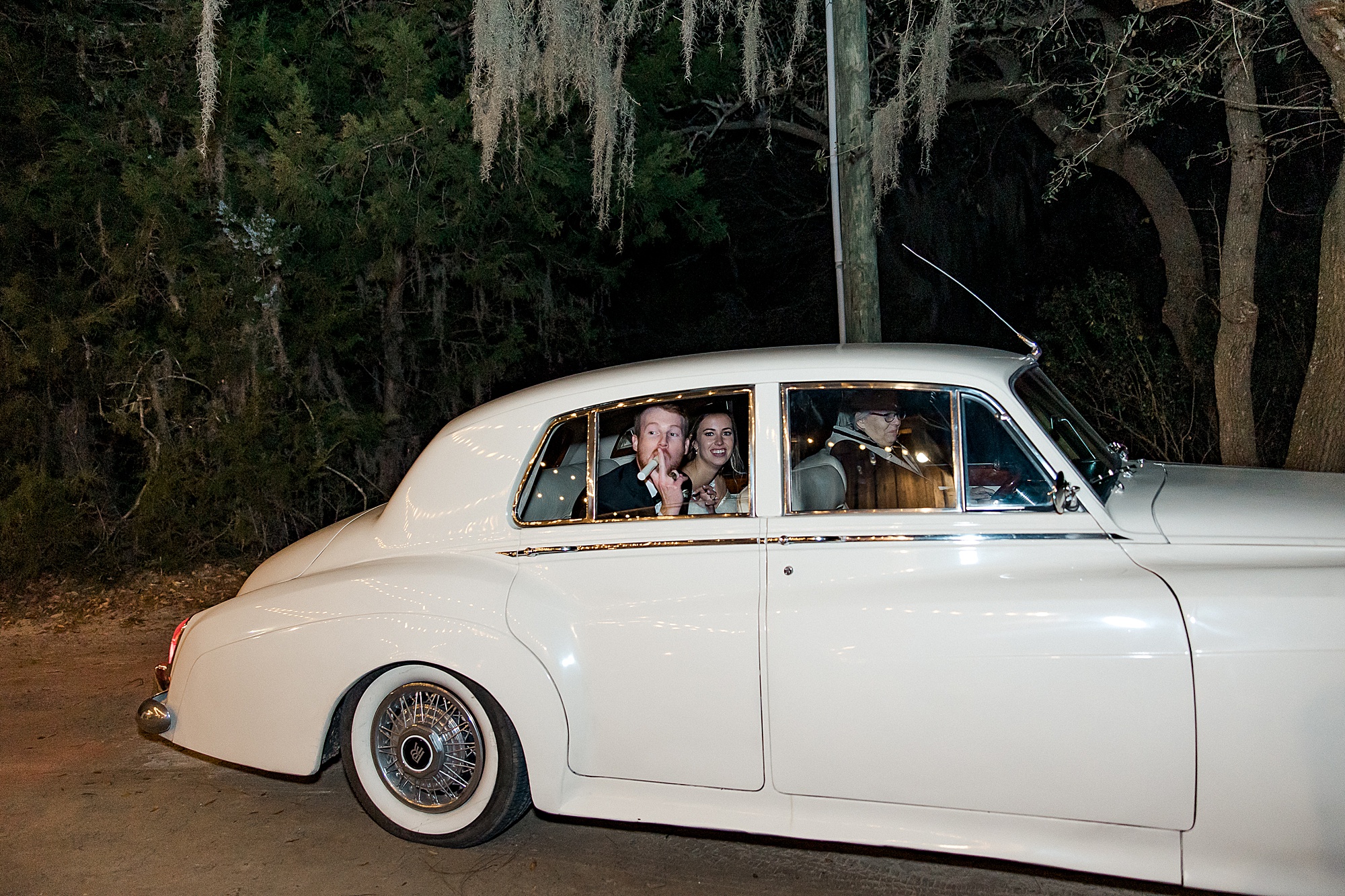 newlyweds exit the Boone Hall Plantation Wedding in a getaway car