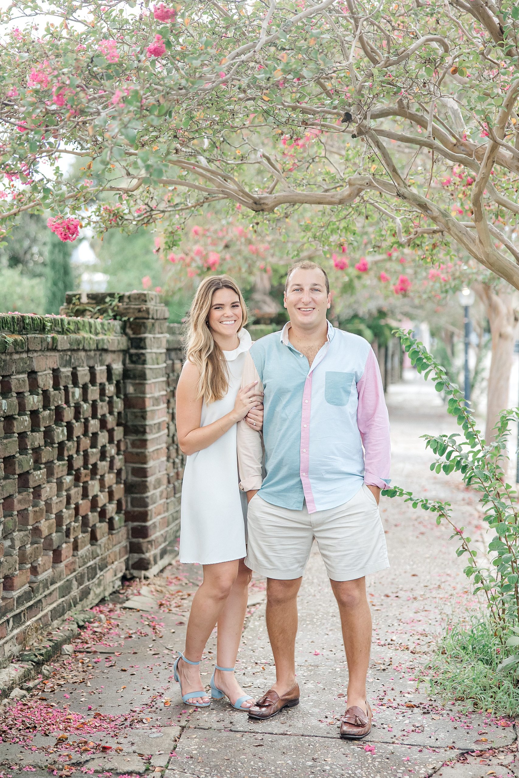 engagement photos of couple under blossoming tree