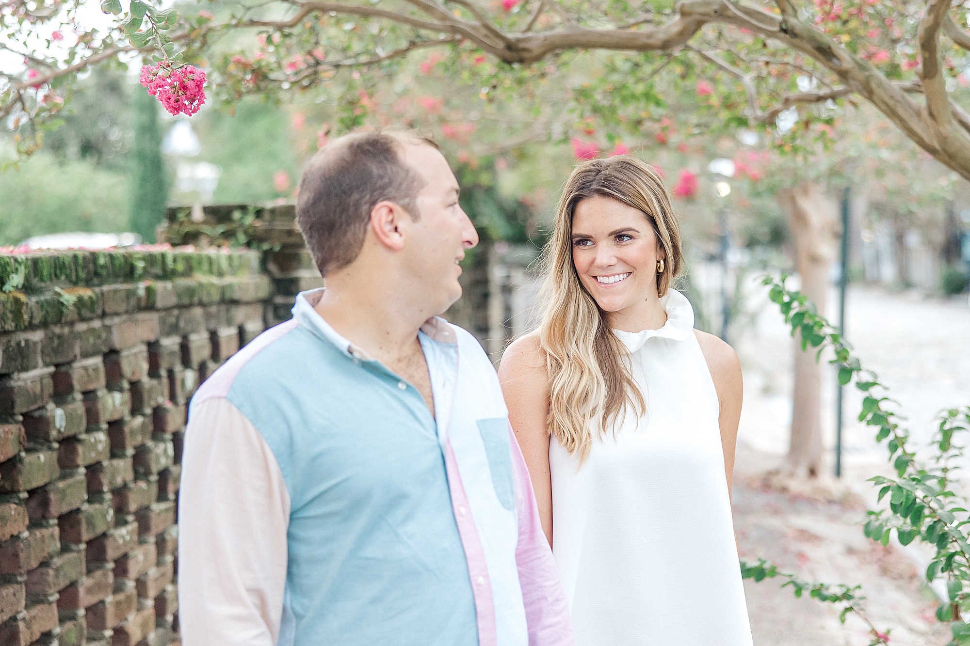 couple look at each other during Downtown Charleston Engagement Session