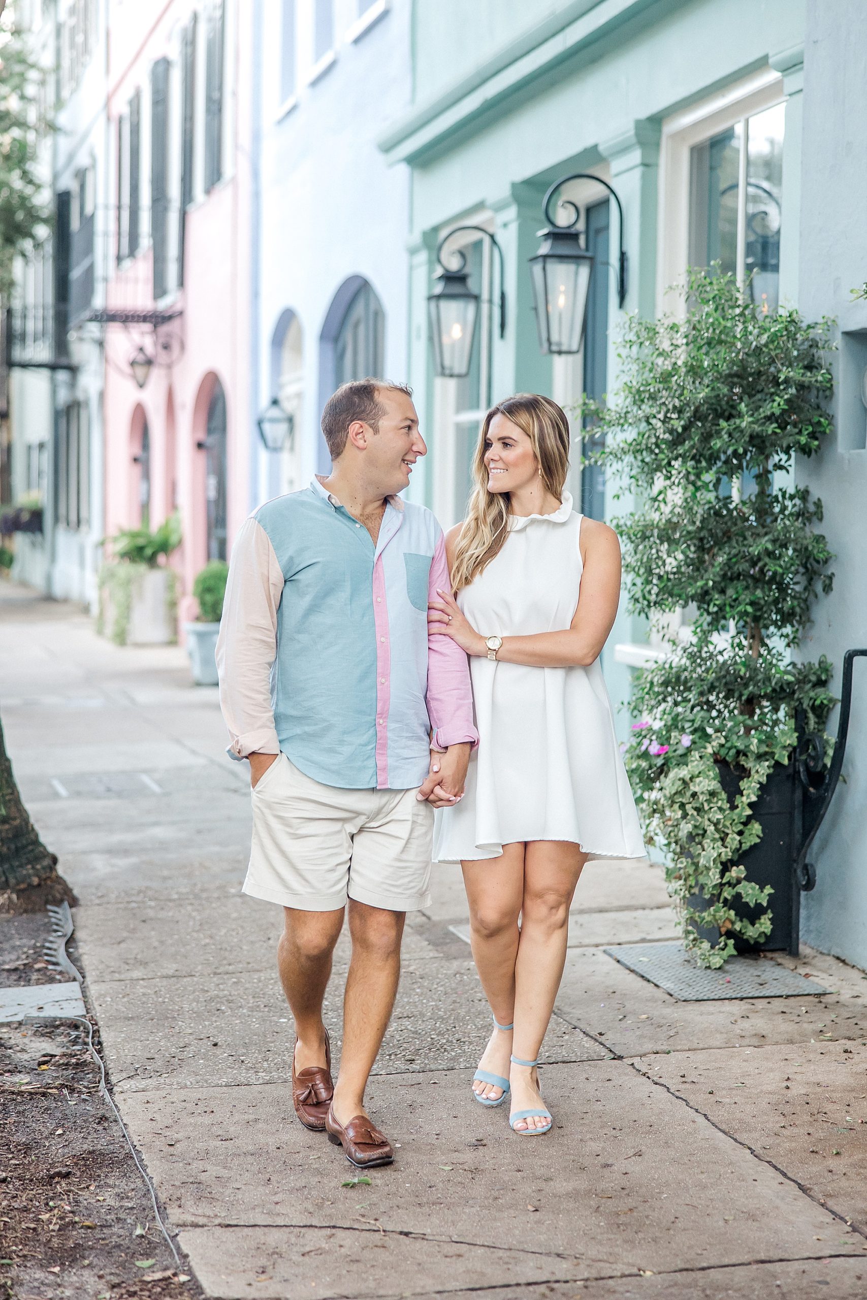 couple walking down street in Downtown Charleston SC for Engagement Session of