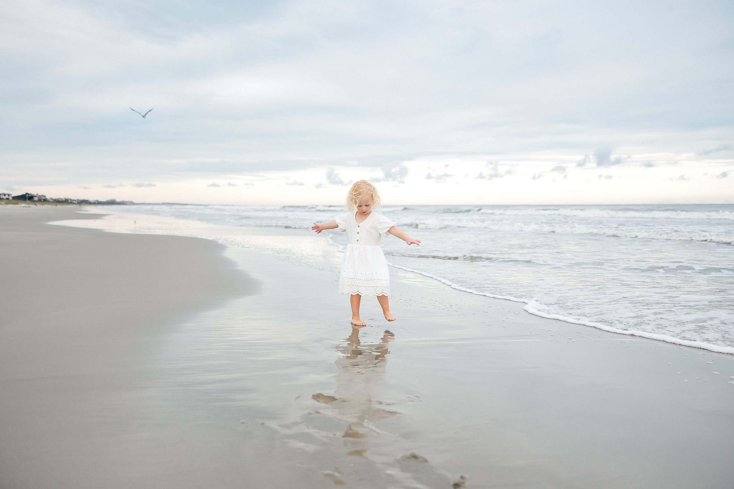 Little girl plays on beach on Kiawah Island South Carolina