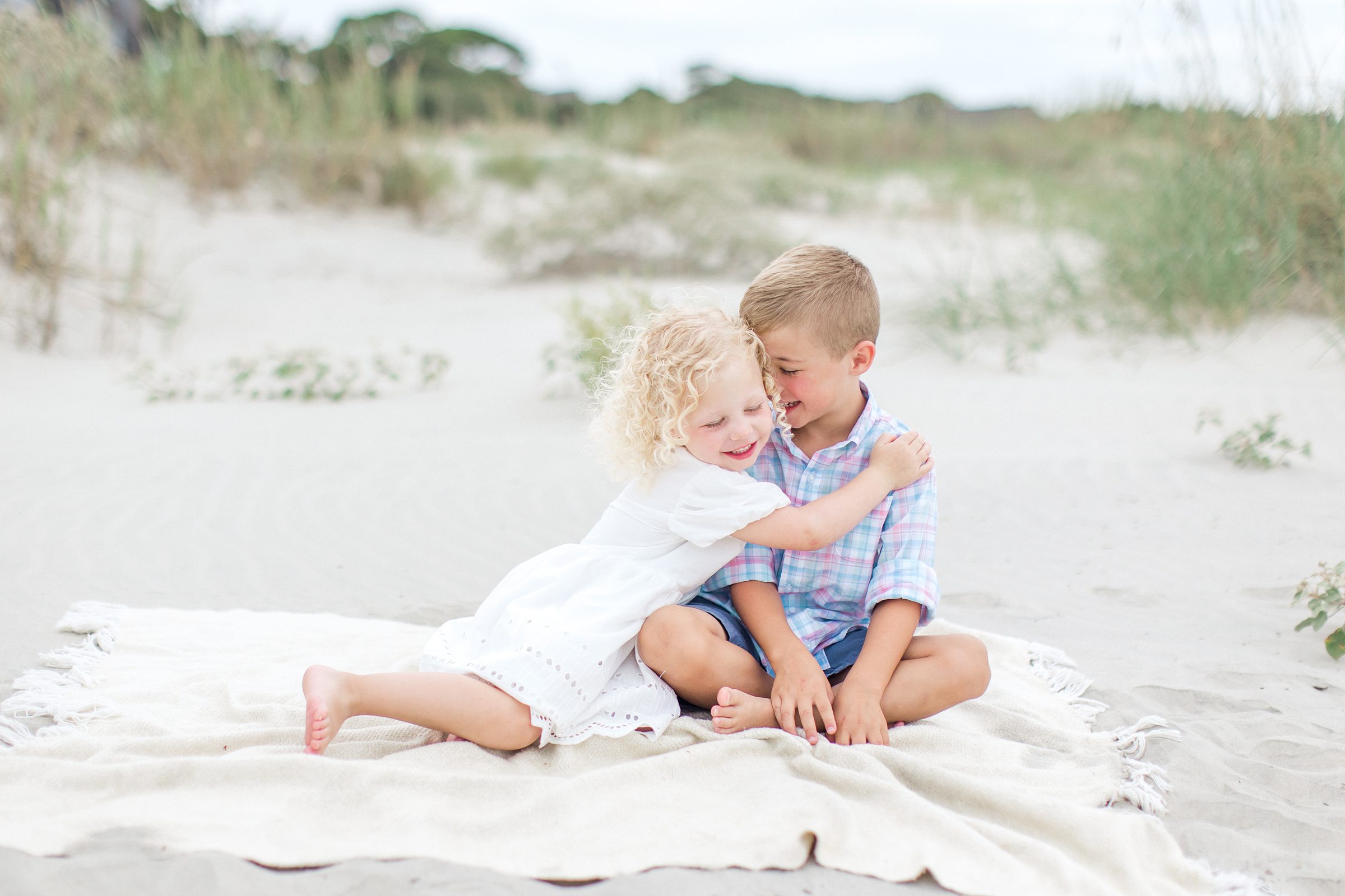 Brother and sister hug on Charleston beach