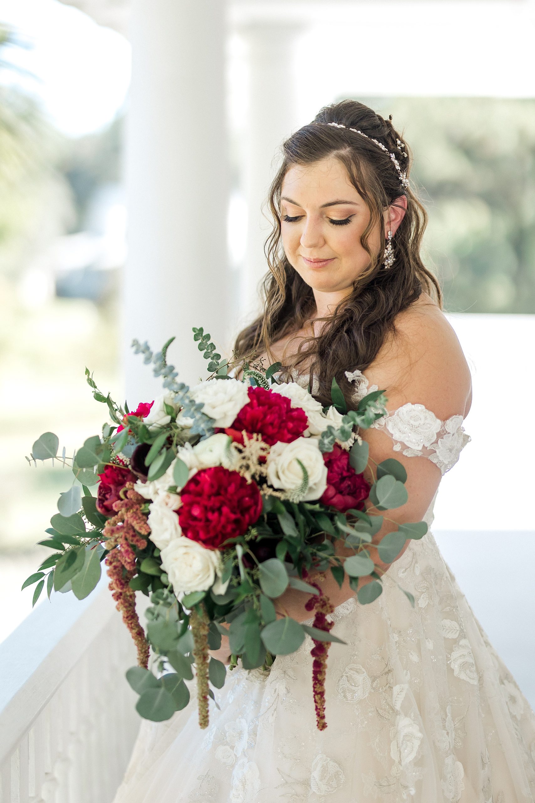 bride holding white and red flower wedding bouquet