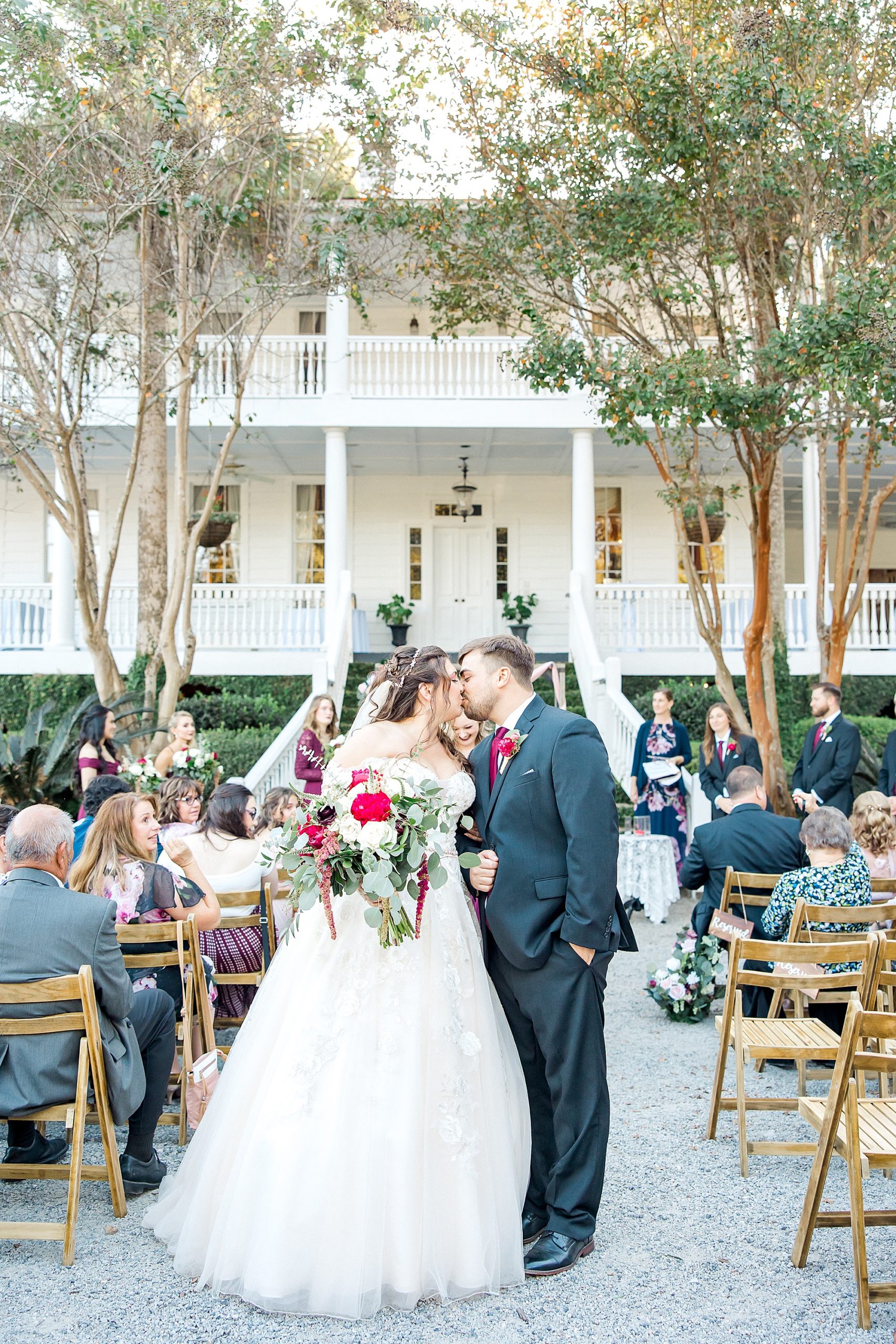 newlyweds kiss at their wedding in Charleston SC