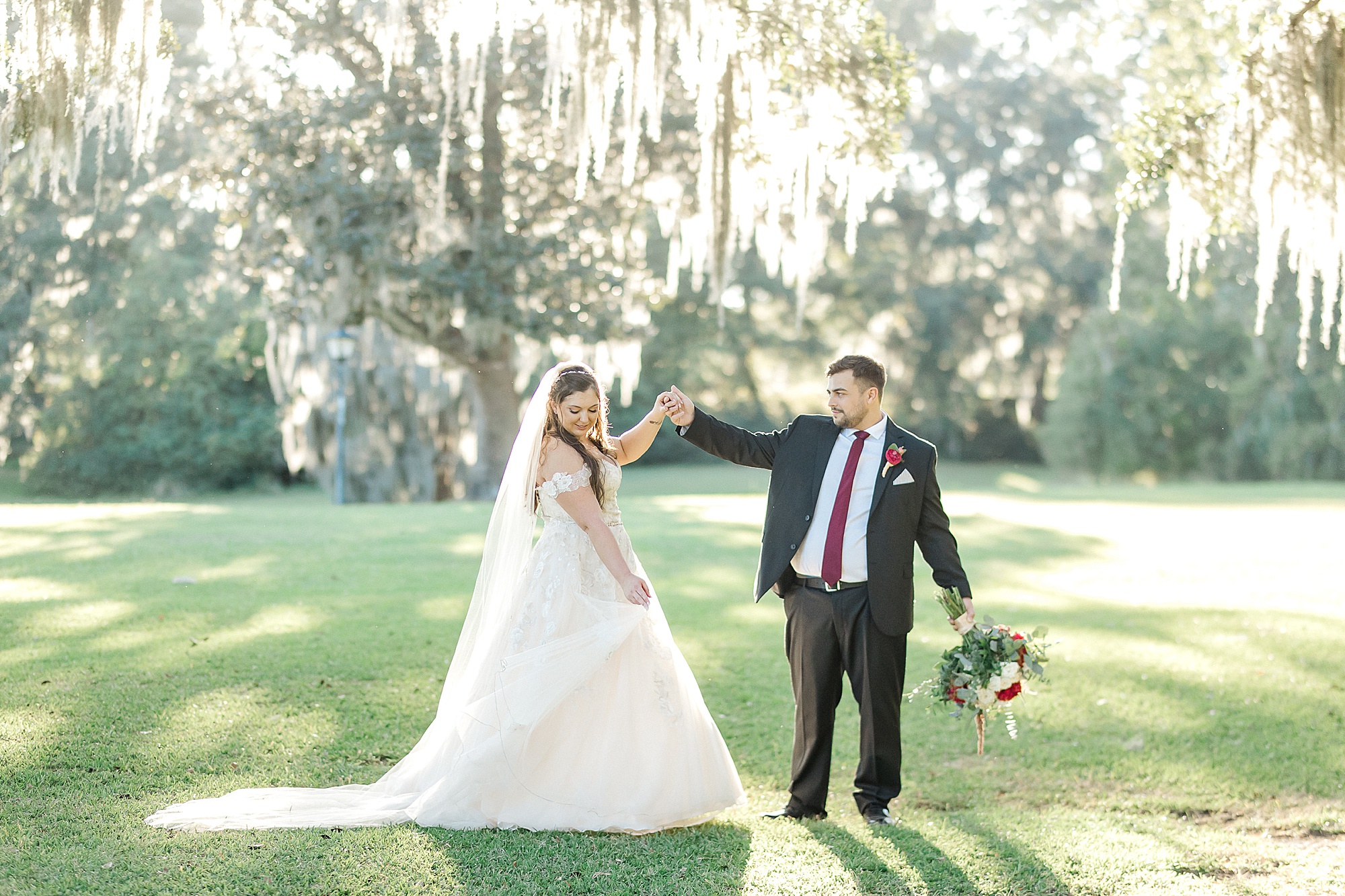 husband twirls his new wife around on the beautiful grounds of Old Wide Awake Plantation