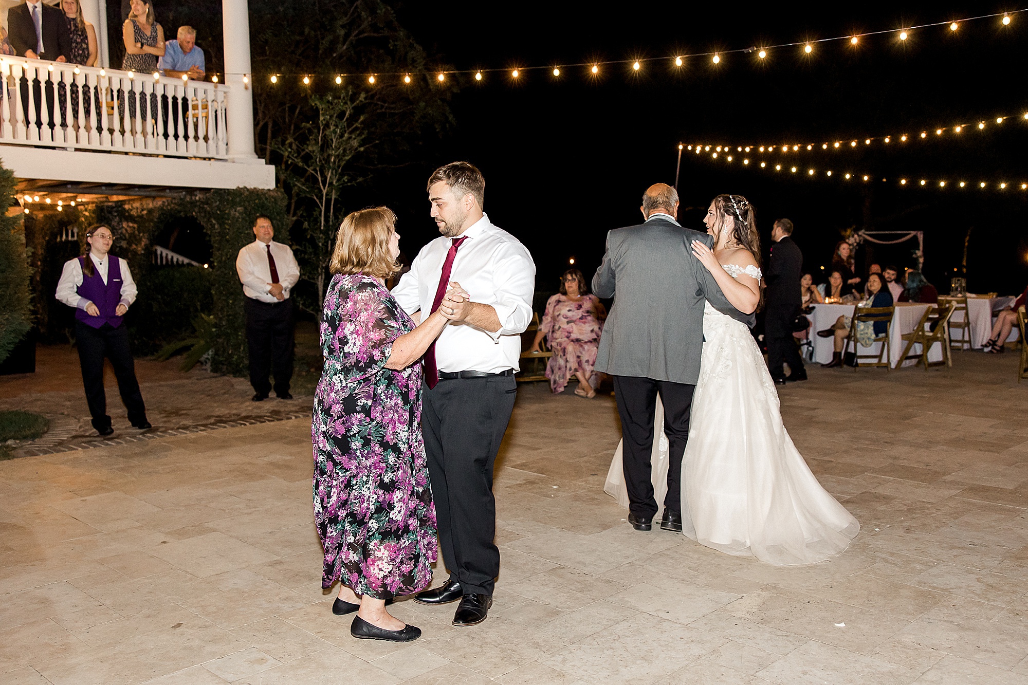 bride and groom dance with family members