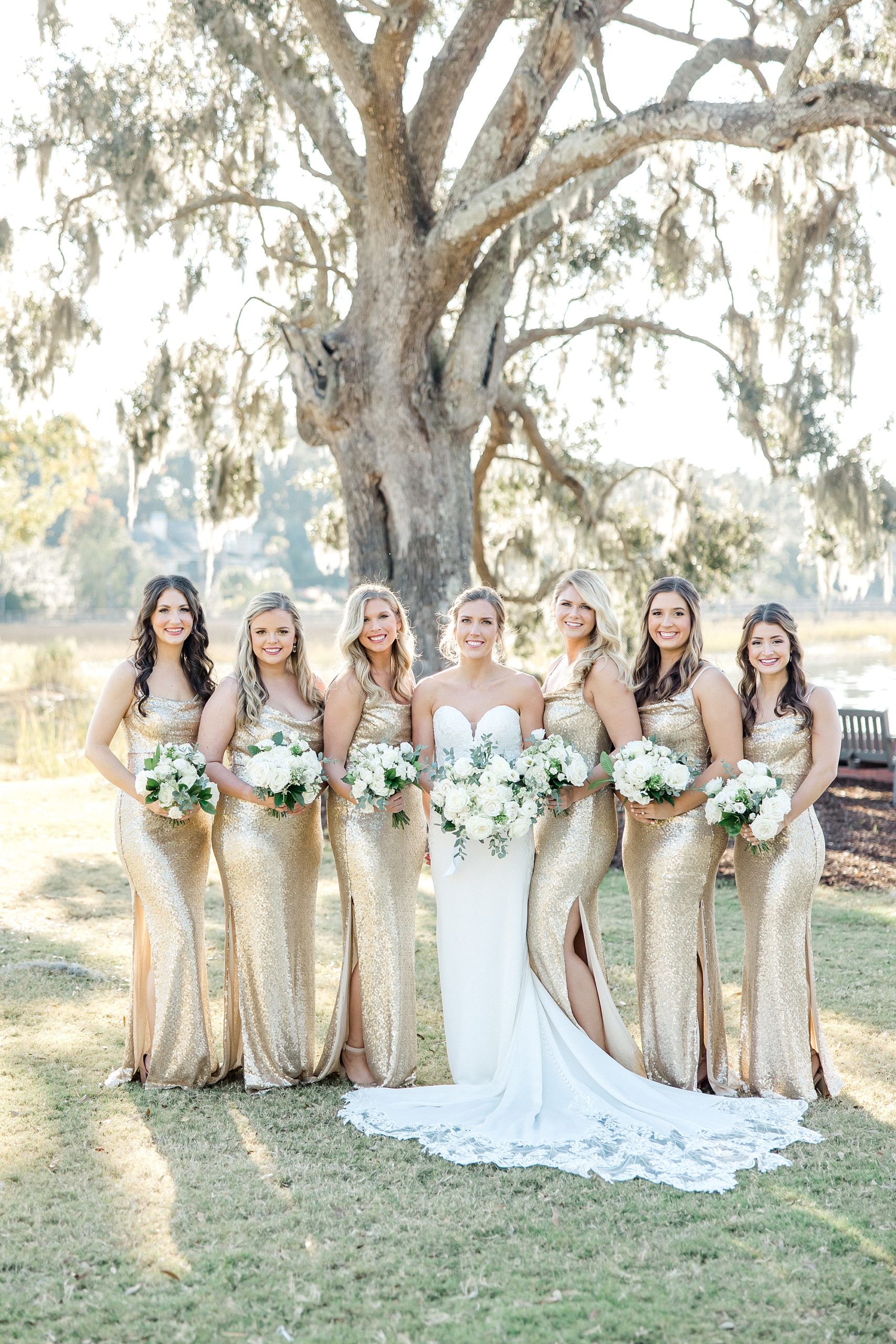 bridesmaids in gold dresses stand with bride