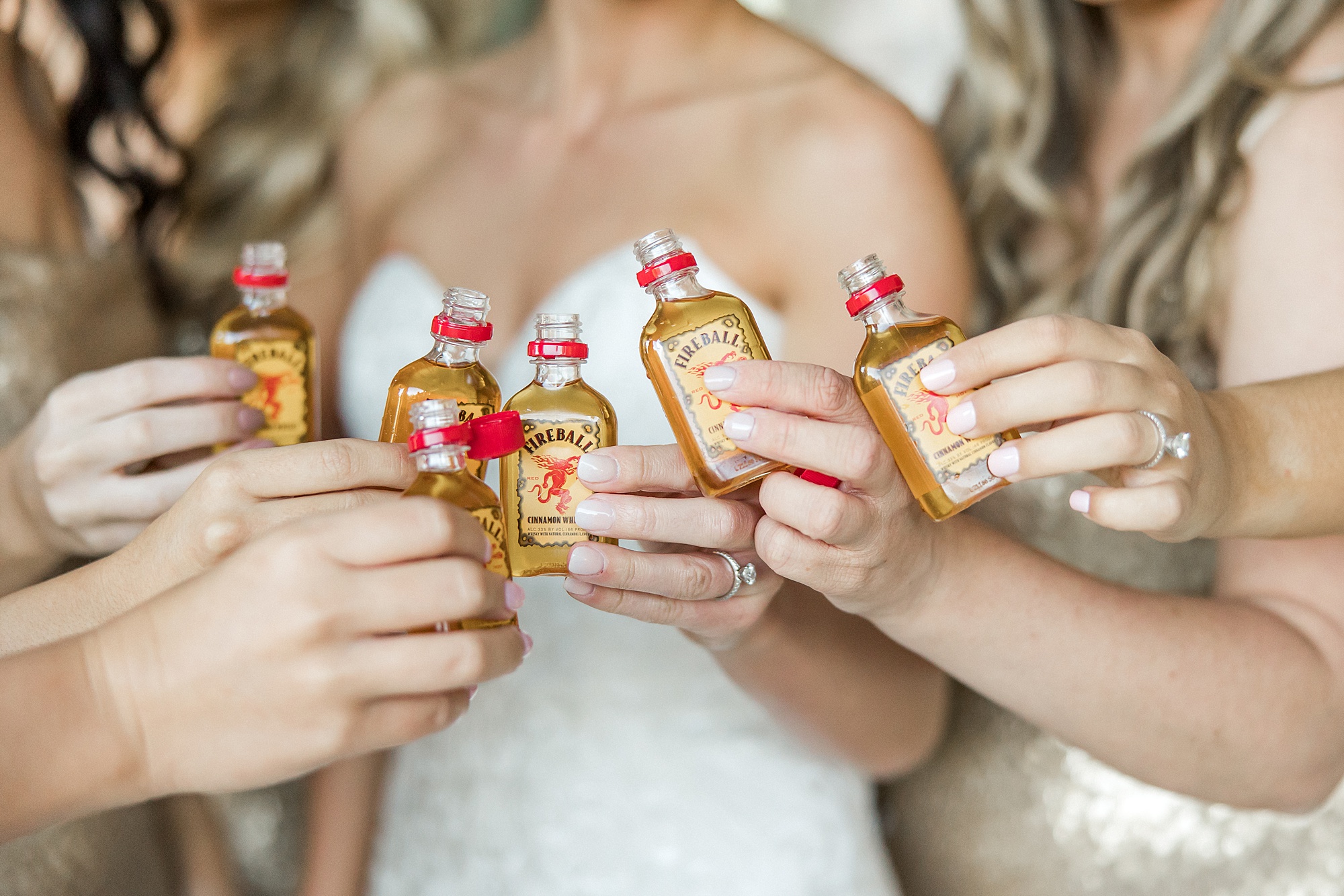 bride and bridesmaids cheers with shots of fireball