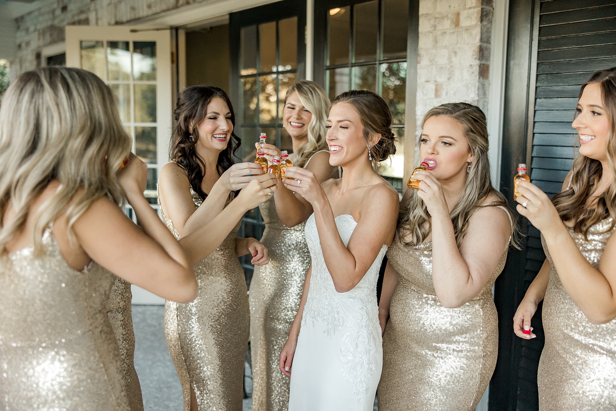 bride and bridesmaids toast before wedding ceremony