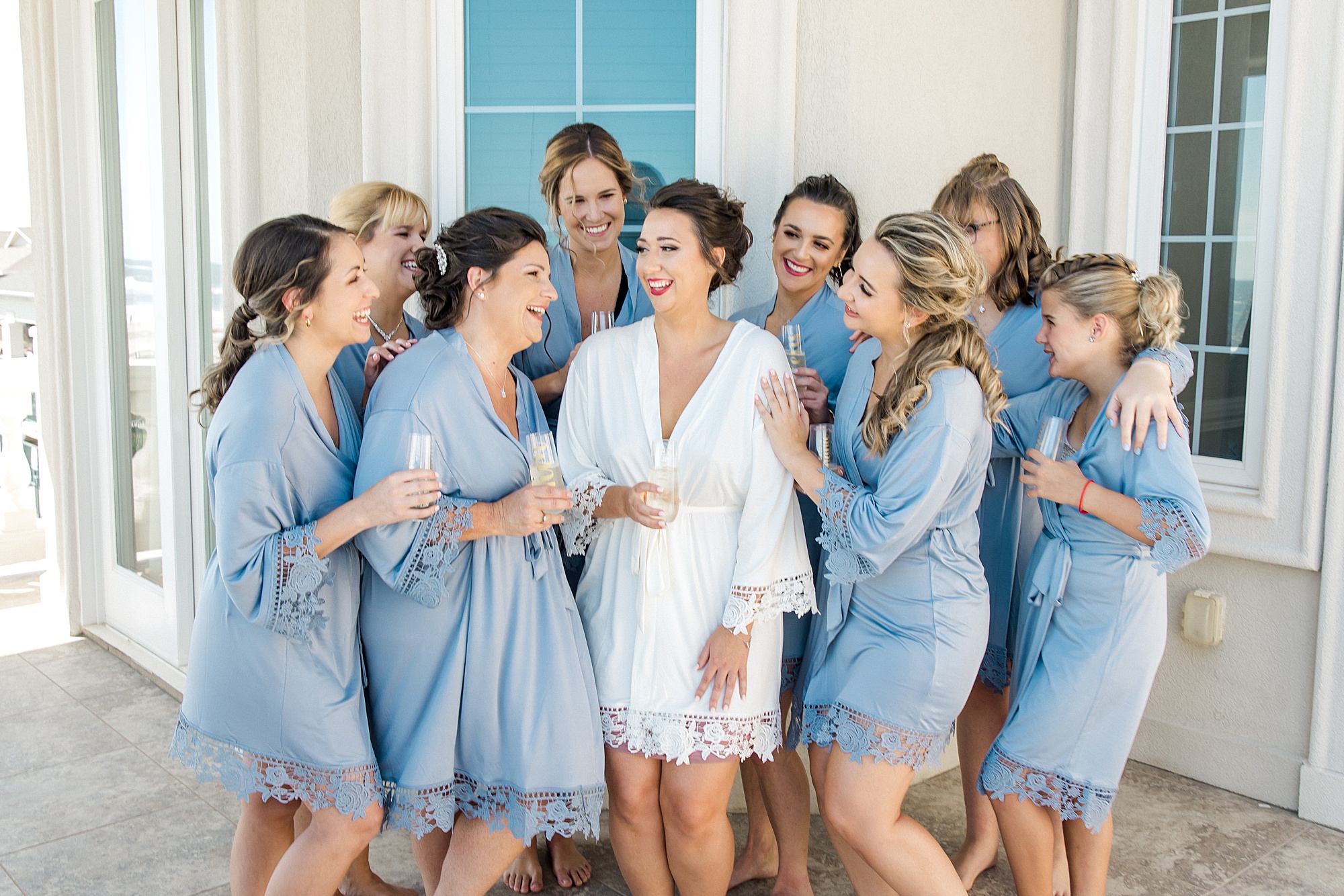 bride and bridesmaids toasting while getting ready