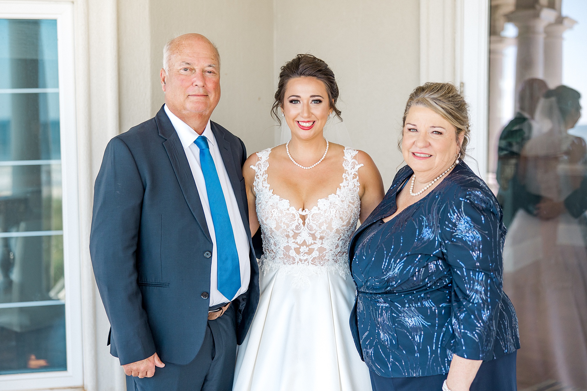 bride with parents before beach wedding ceremony