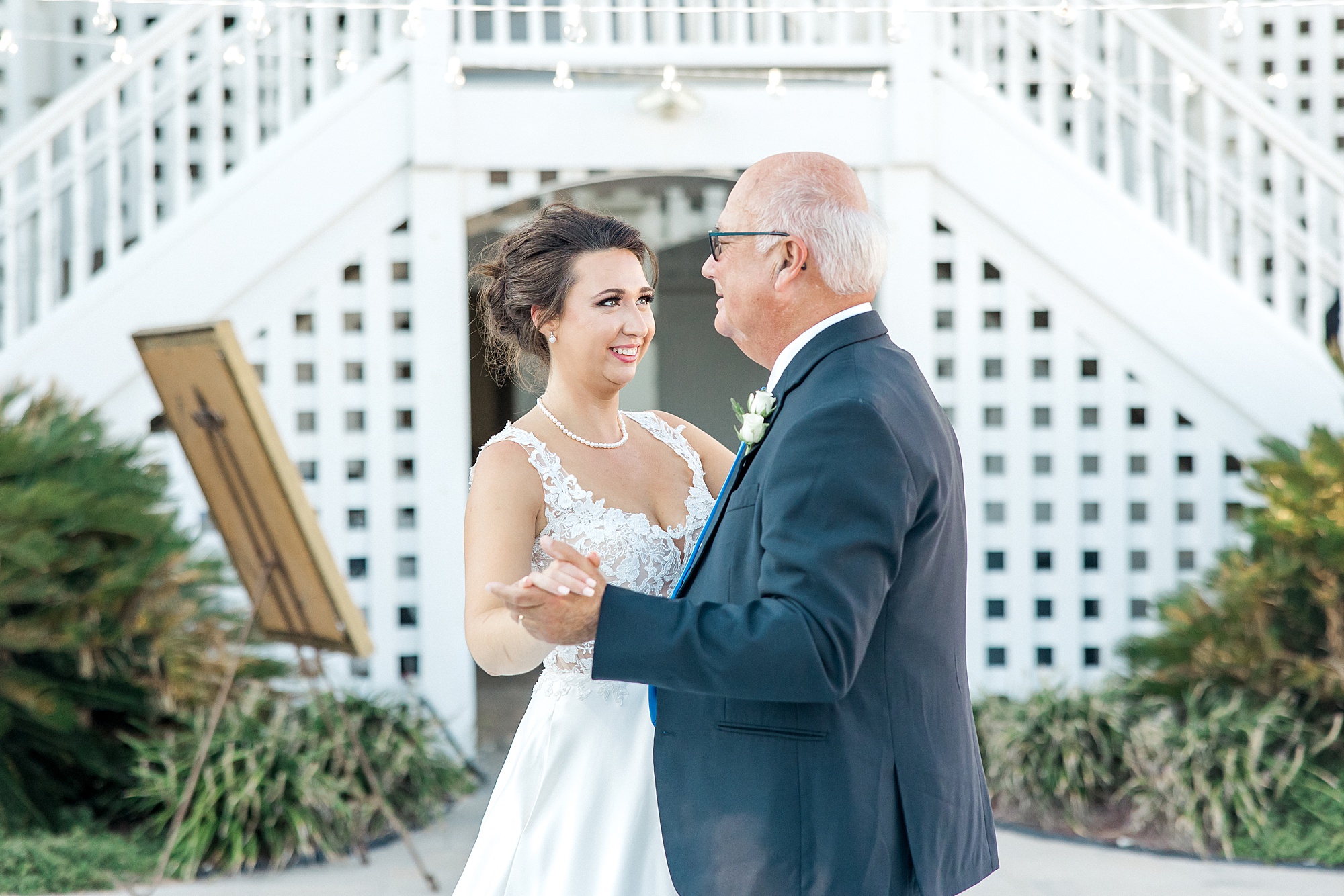bride and her dad dance together