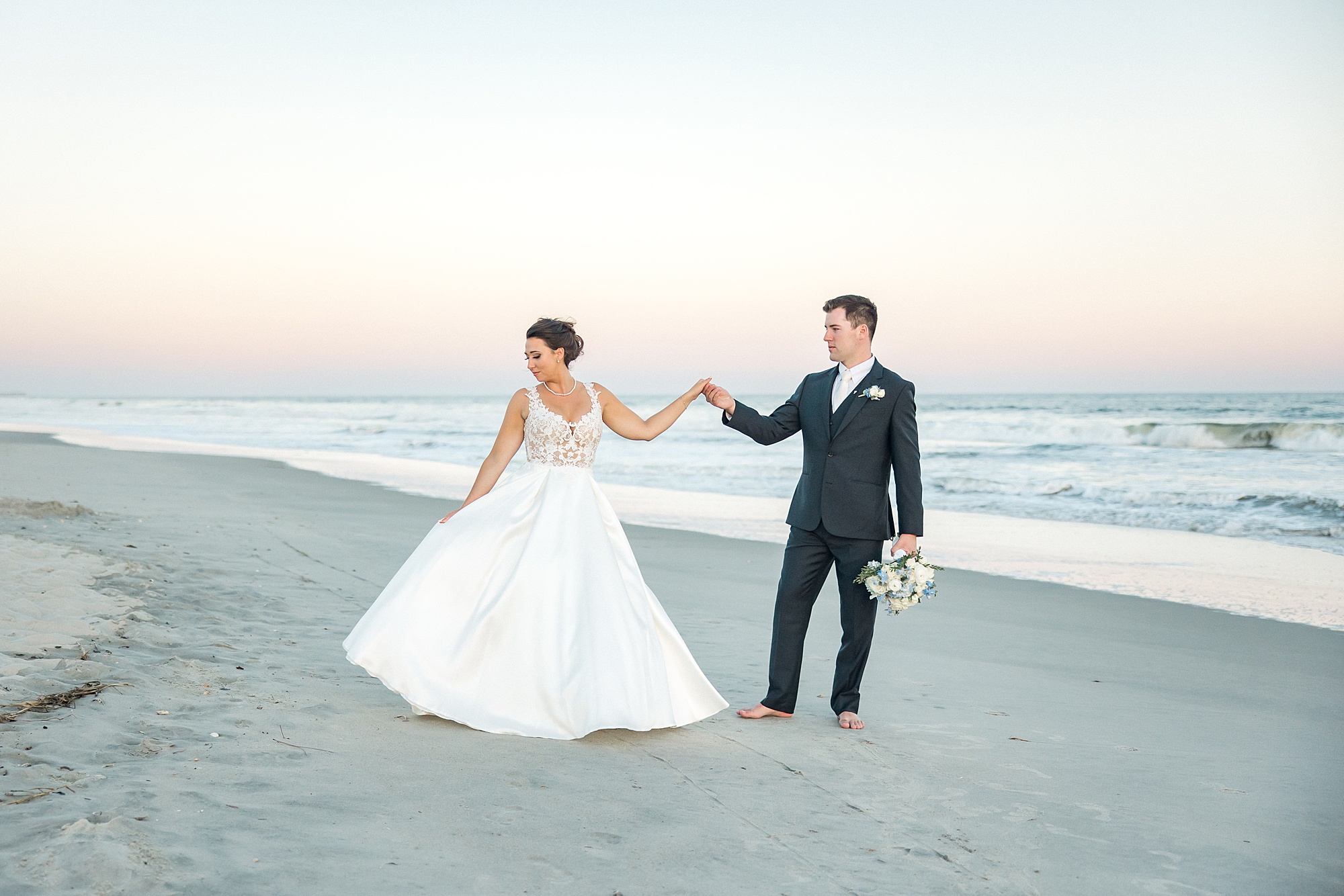 bride and groom portraits on the beach with stunning sunset