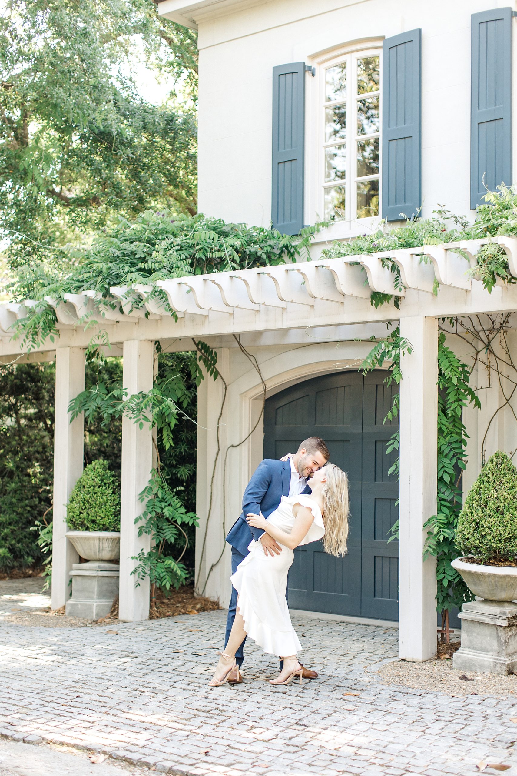 candid moment of couple in front of house in Charleston SC