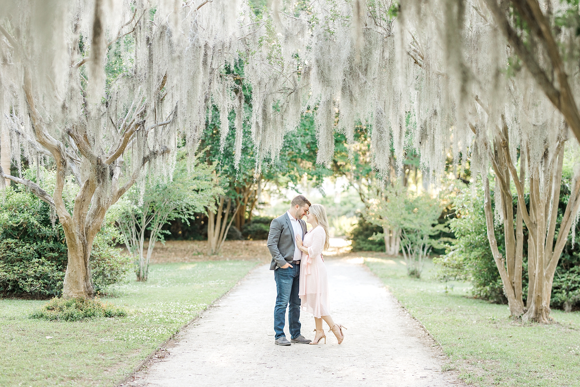 engaged couple under the Spanish moss in Charleston SC