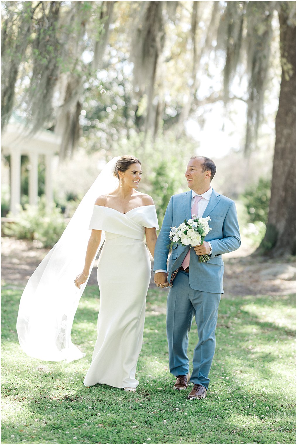 couple walk in front of the William Aiken House for Wedding portraits