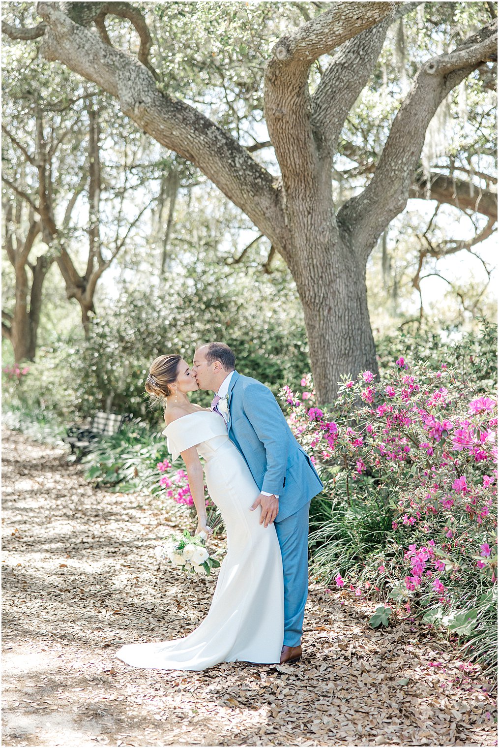 couple kiss next to the blooming azaleas