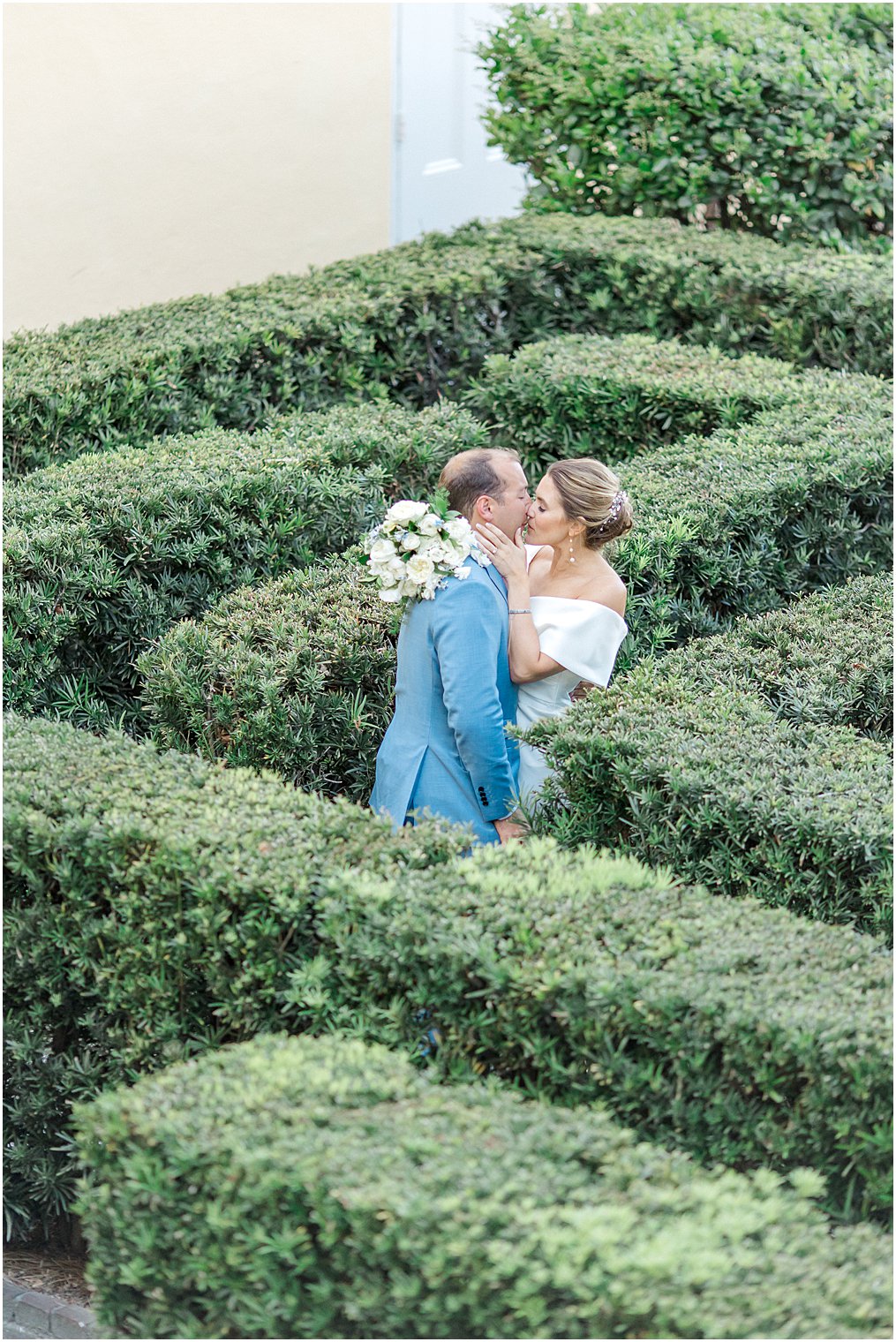 couple kiss in the garden maze