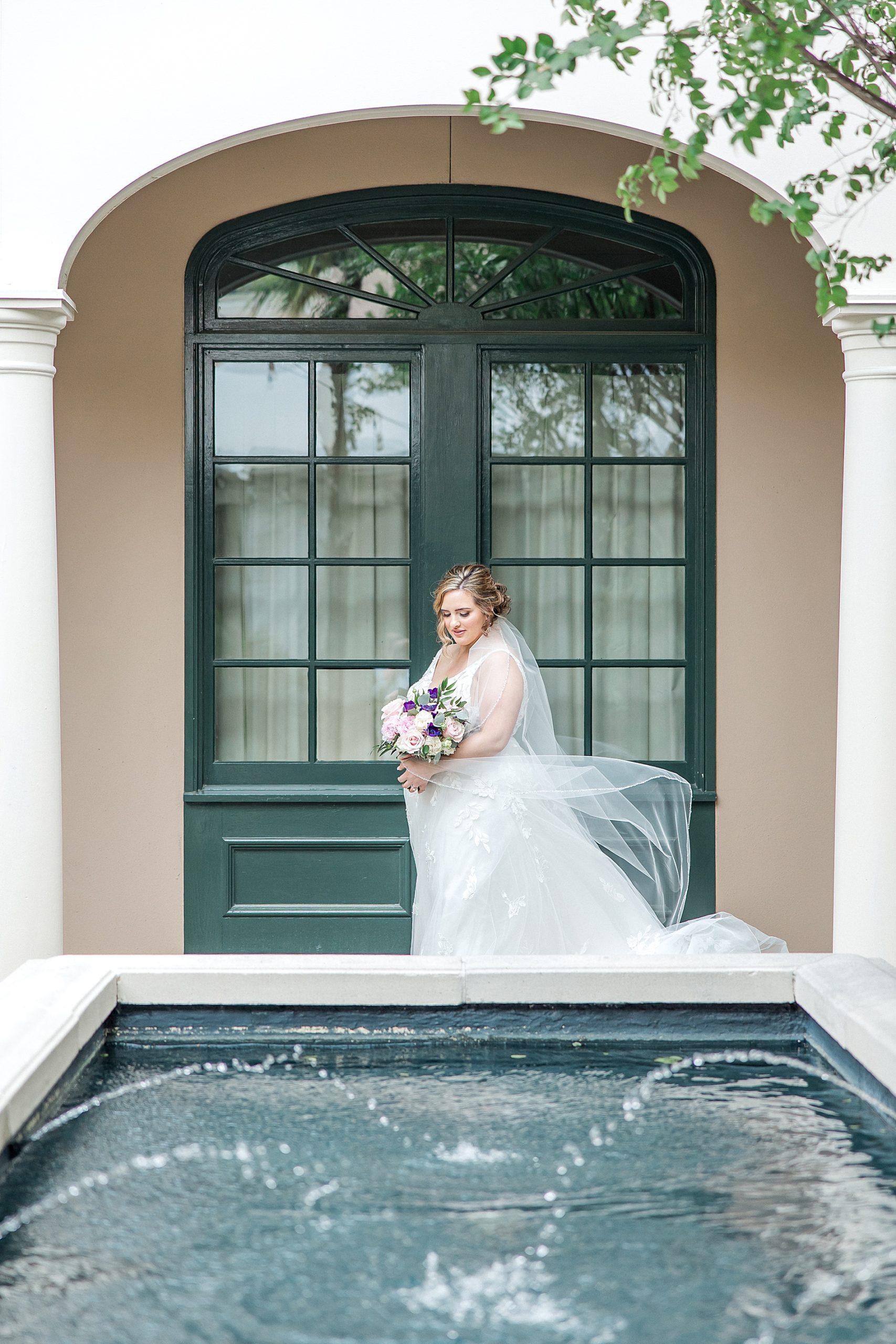 bride by water fountain