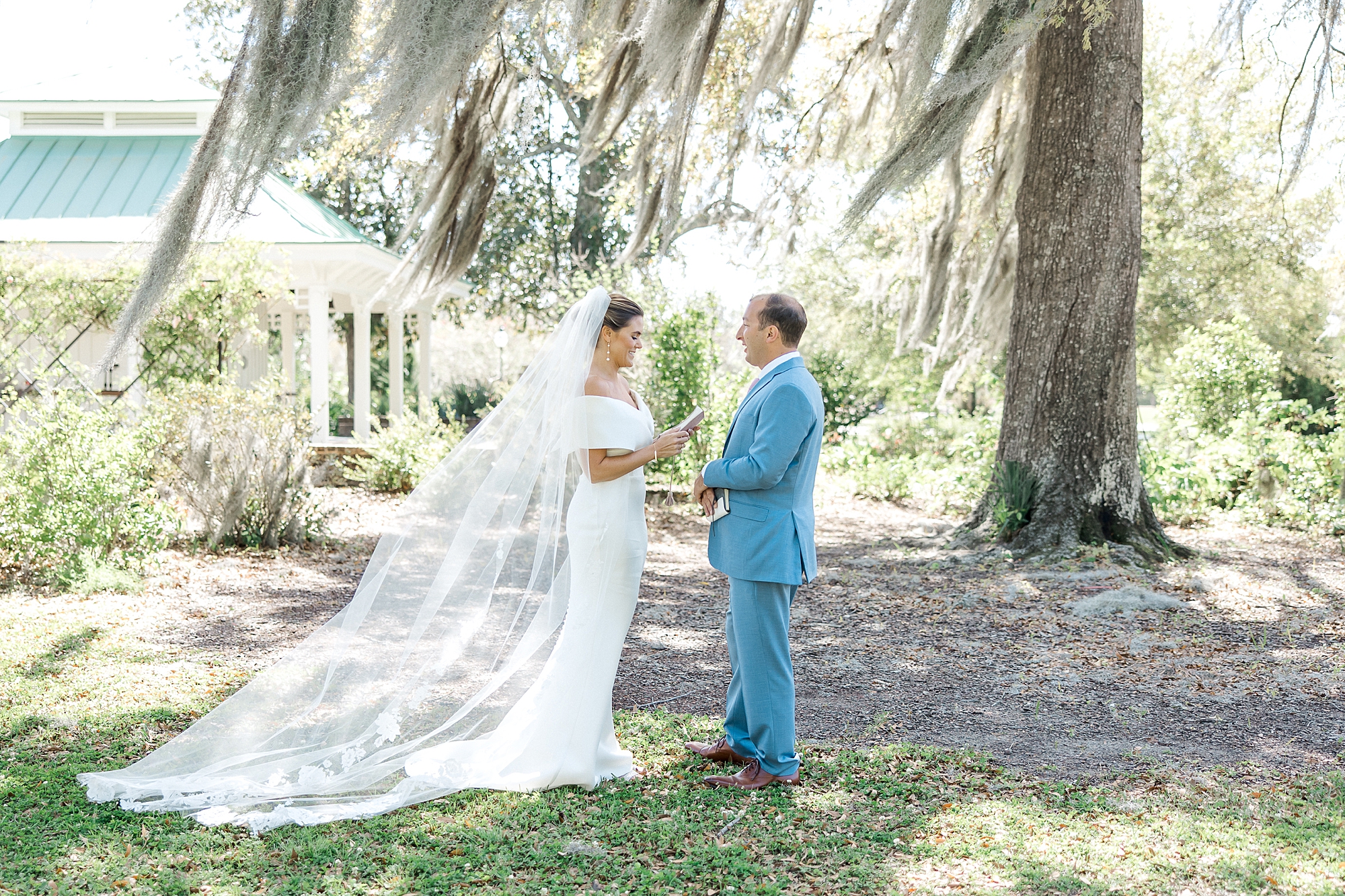 couple exchange private vows under Spanish moss covered ak tree