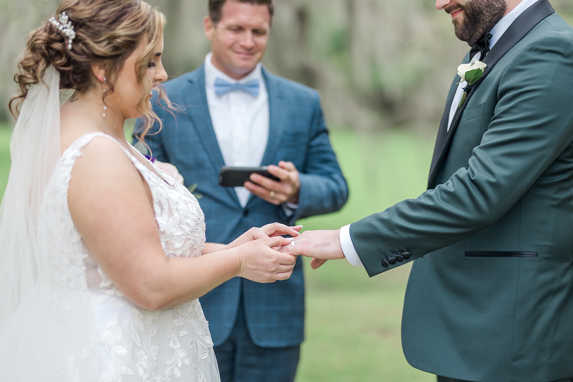 bride and groom exchange wedding rings