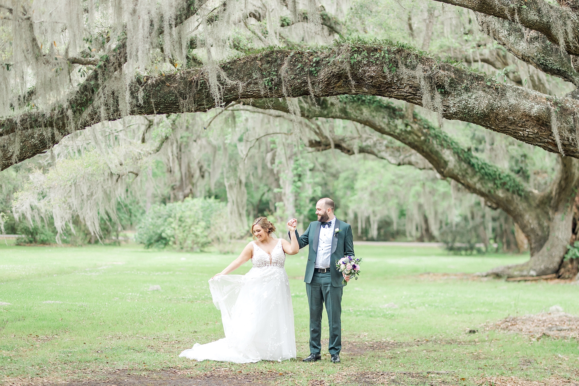 Charleston SC wedding photographer captures couple under spanish moss covered oak tree