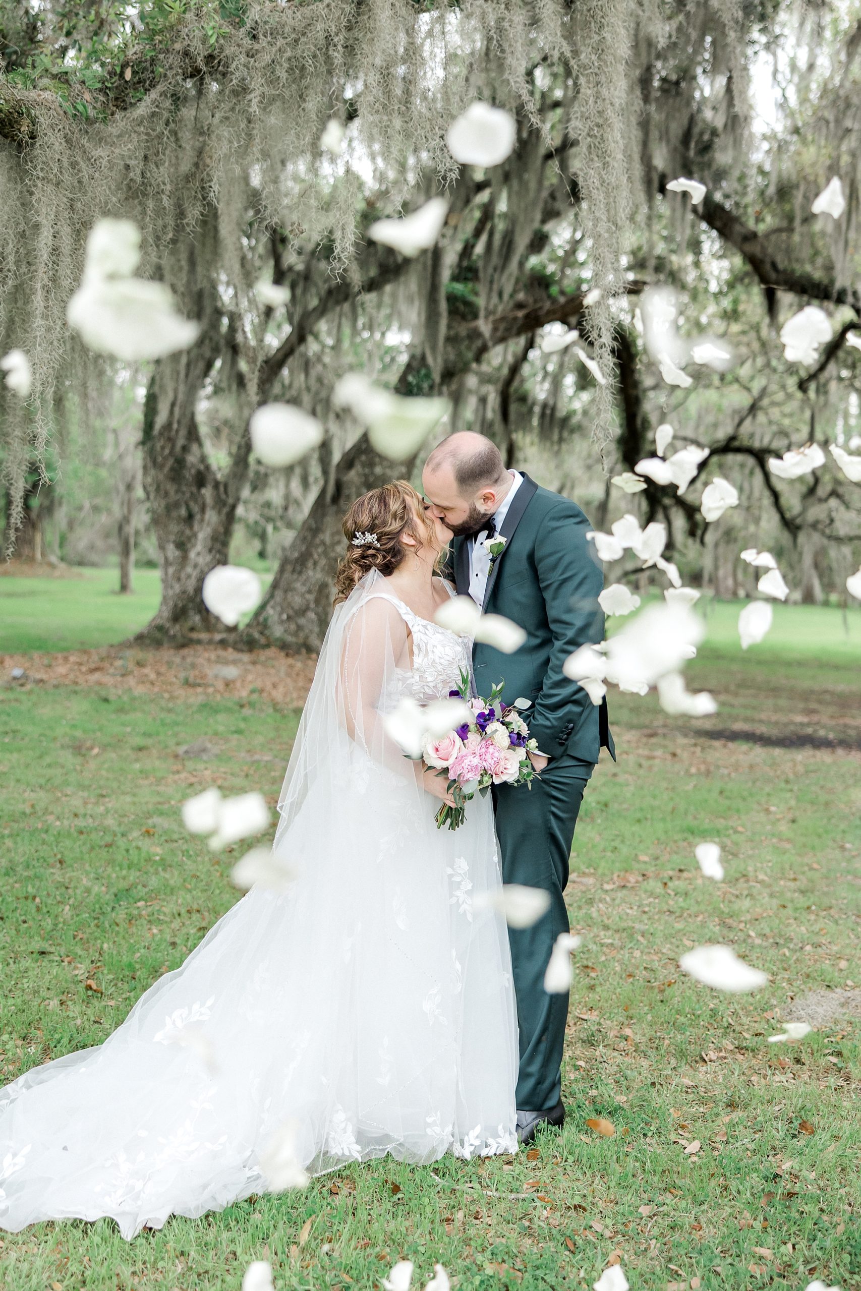 flowers rain down on bride and groom as they kiss
