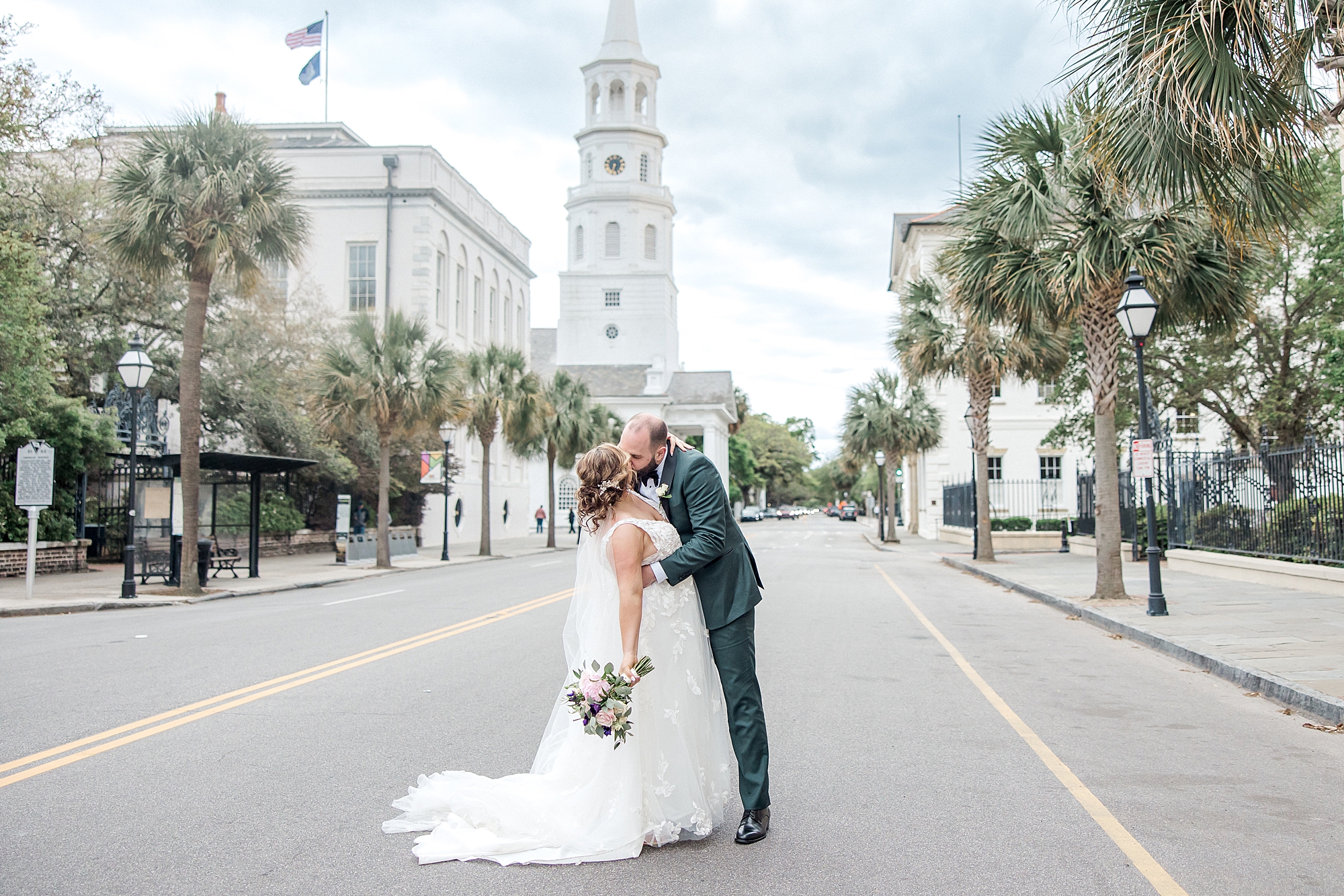 couple kiss in the middle of street in downtown Charleston