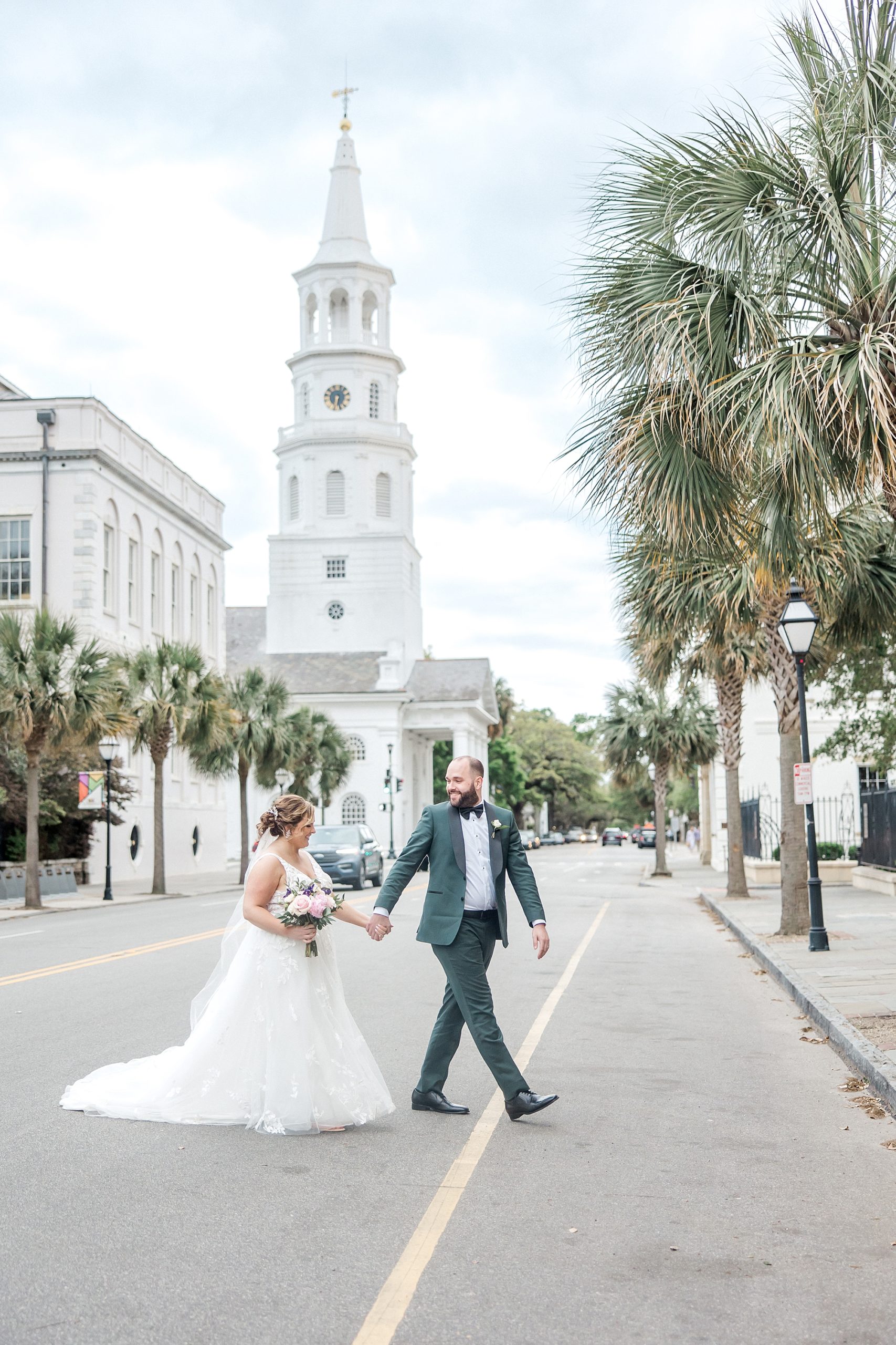 couple walk across street in downtown Charleston