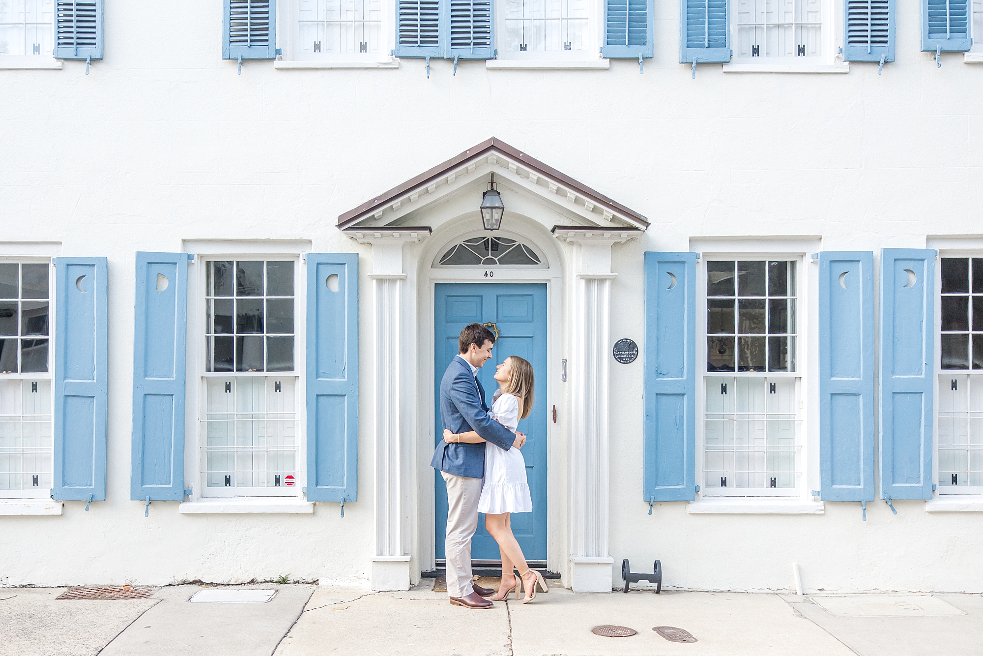 Historic Downtown Charleston Spring Engagement in front of white house with blue shutters