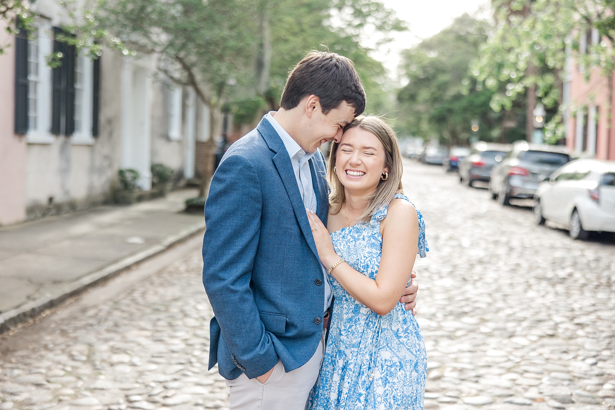 engaged couple in cobblestone street in downtown Charleston SC