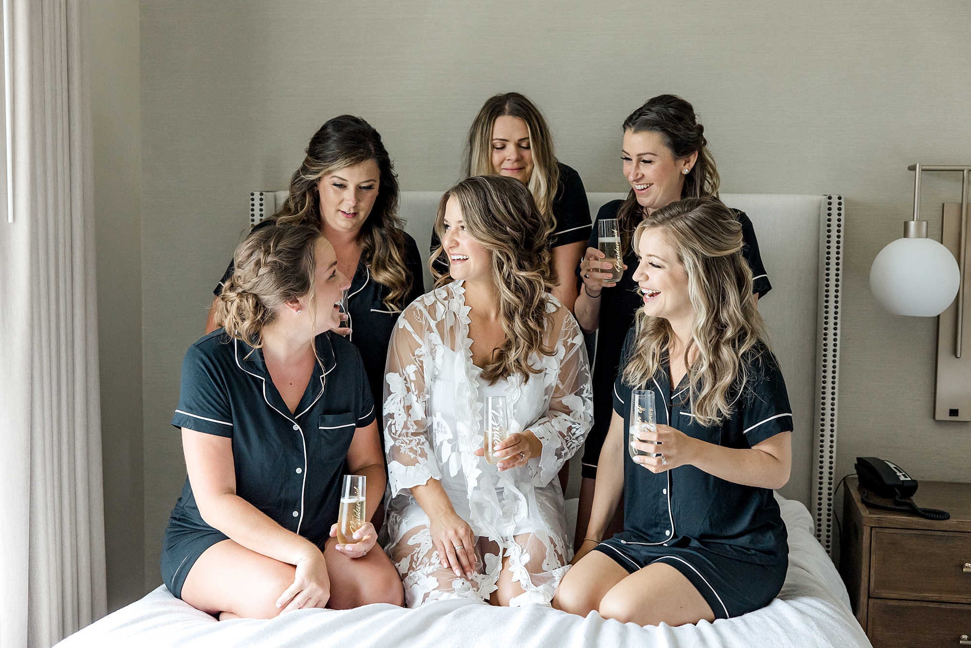 bride and bridesmaids in matching robes before wedding ceremony