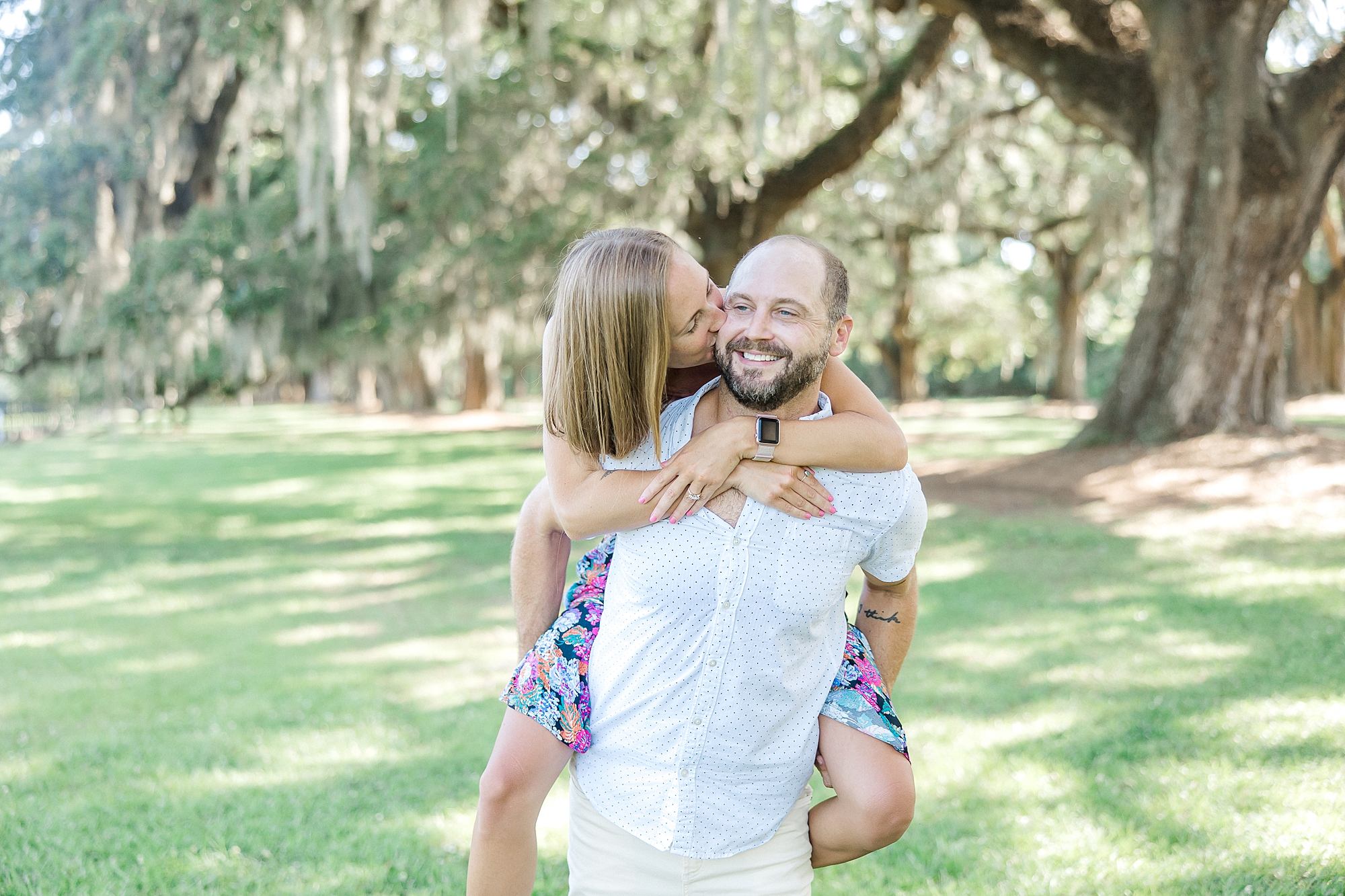 man carries his fiance on his back during engagement session