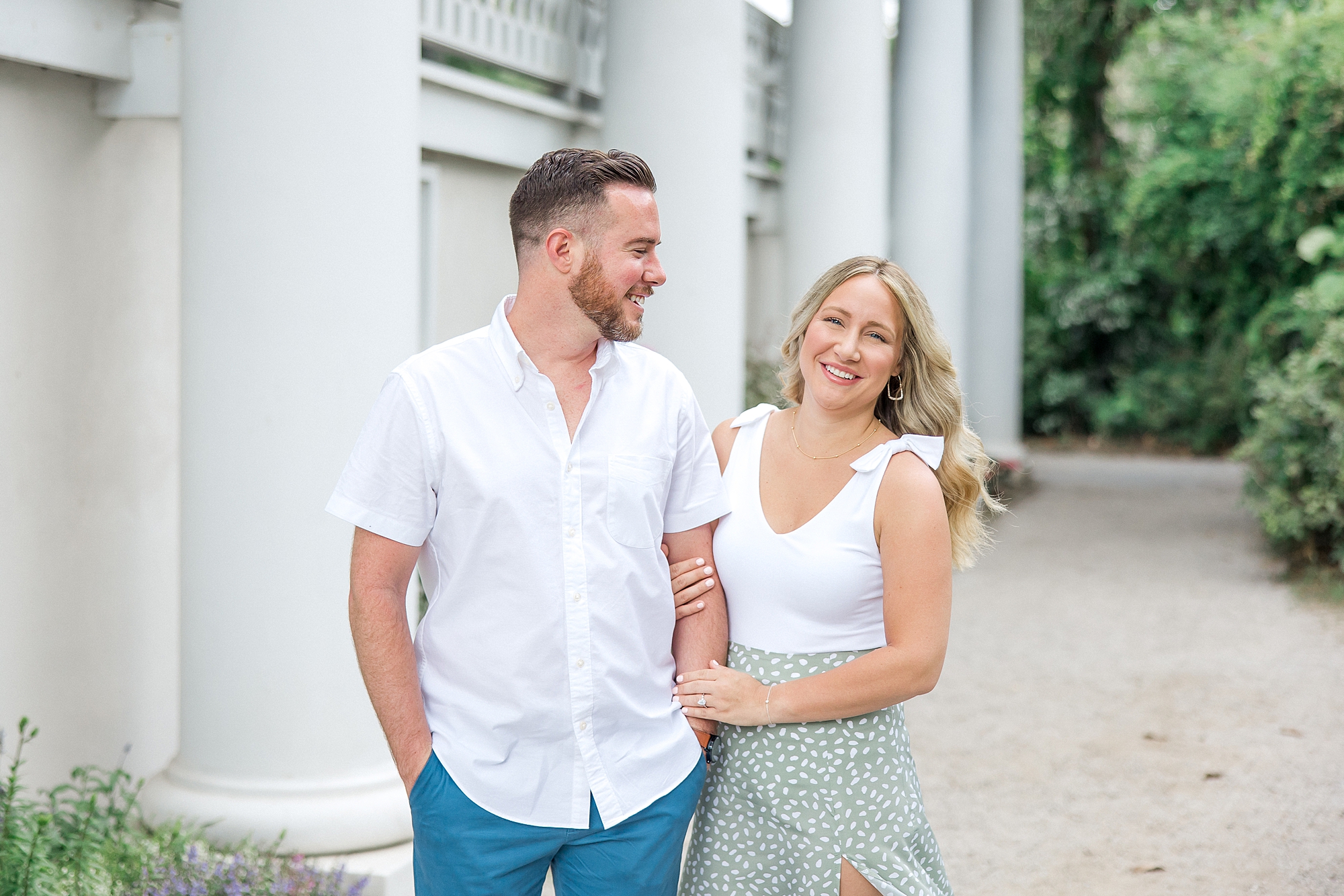 engaged couple stand near plantation house during Romantic Magnolia Plantation and Gardens Engagement