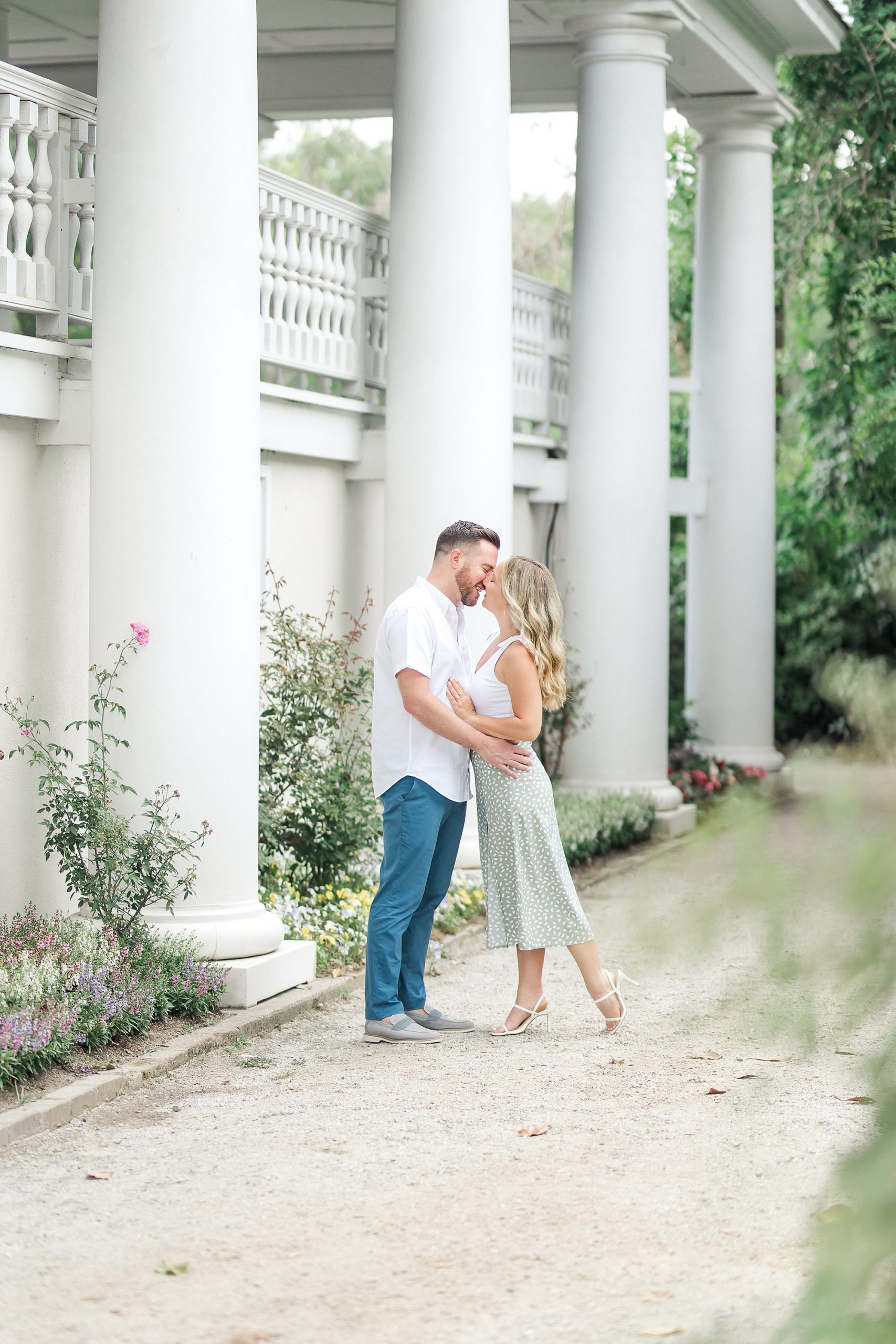 couple lean in together by historic plantation house in Charleston SC