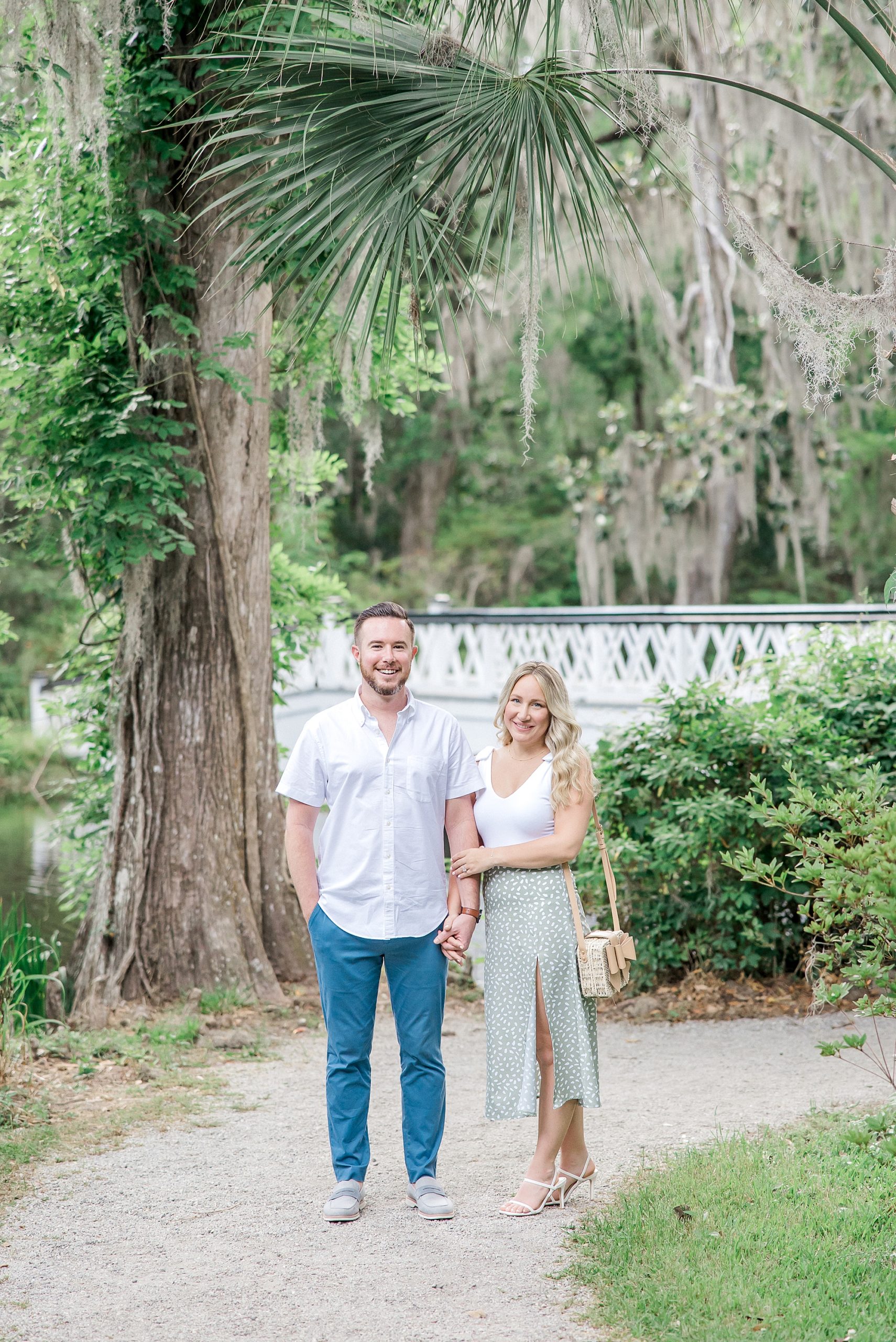 couple walking along path during Romantic Magnolia Plantation and Gardens Engagement