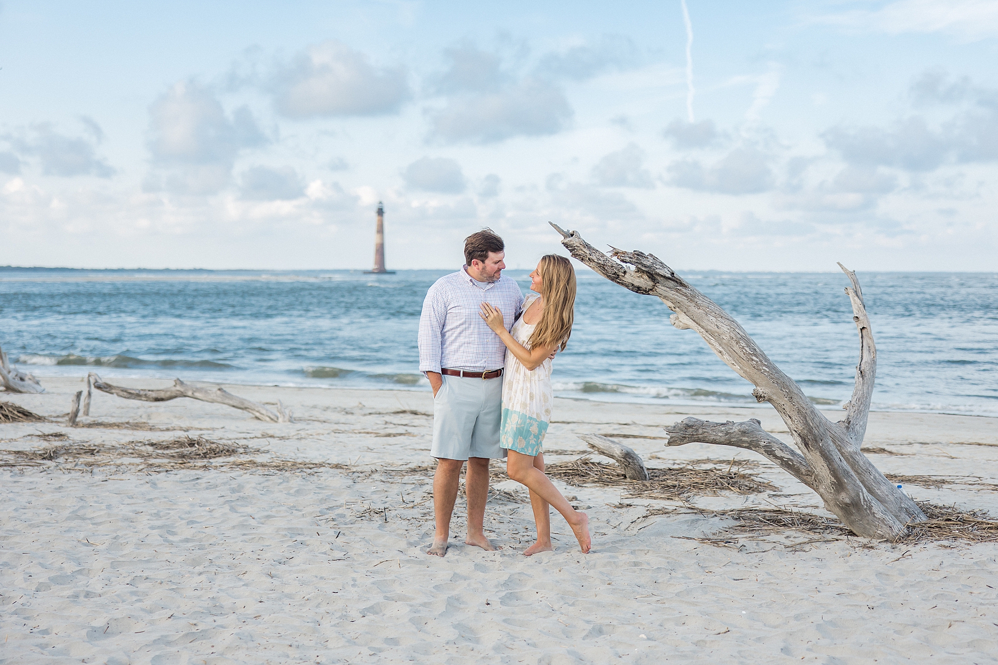 couple on Folly Beach near driftwood for engagement session