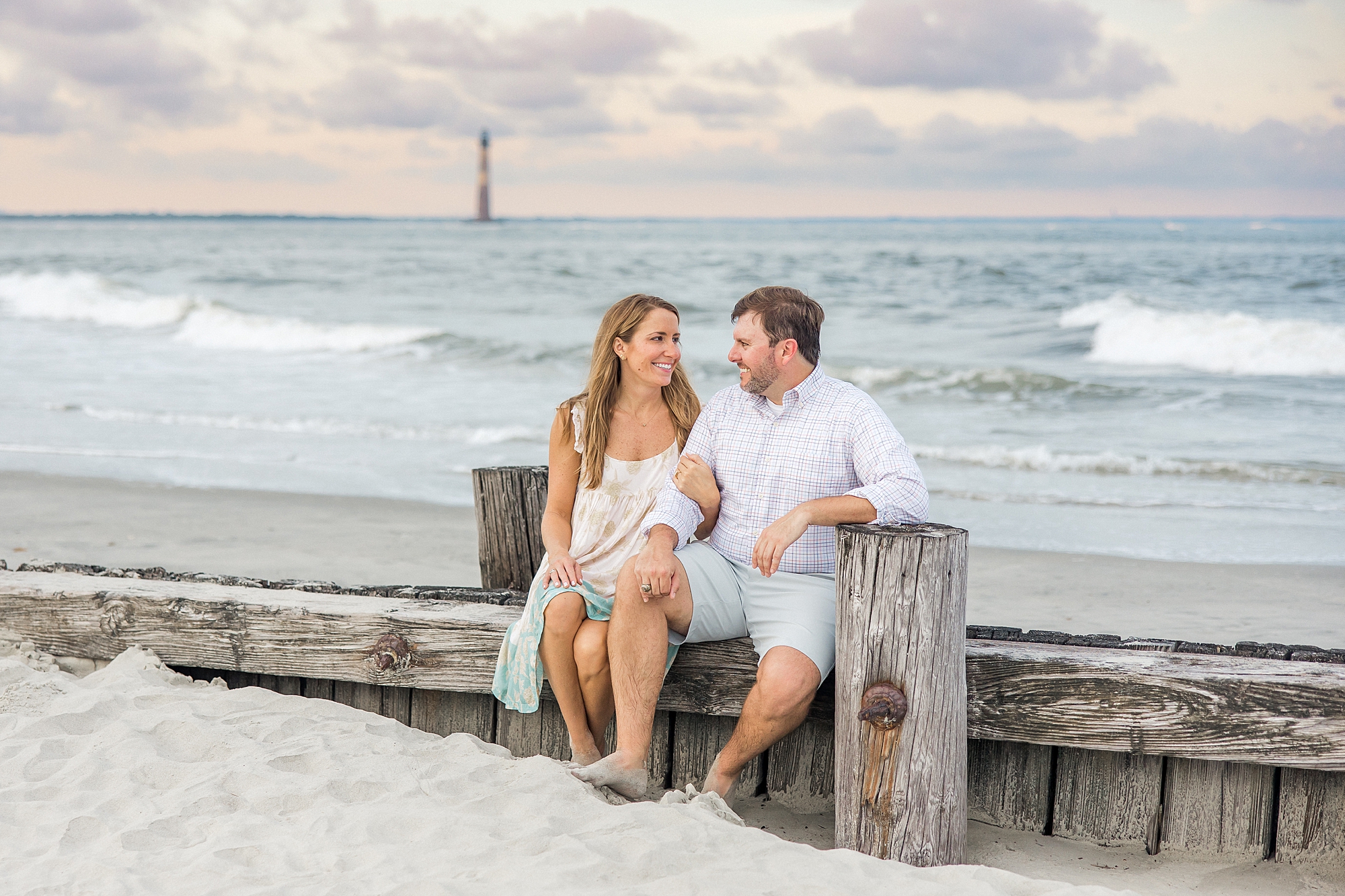 engaged couple sit on wood during SC Engagement session