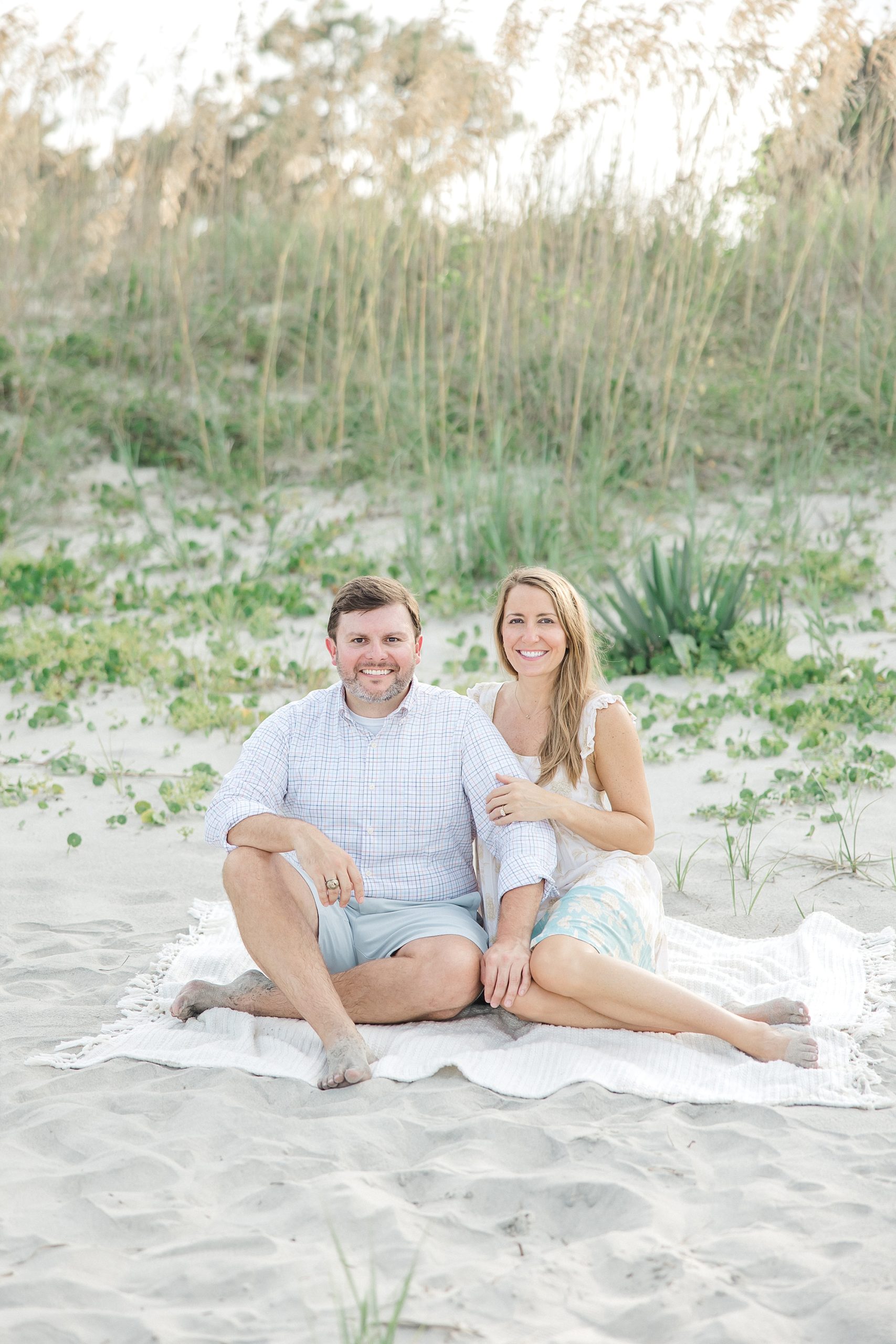 couple sits on blanket at the beach in SC