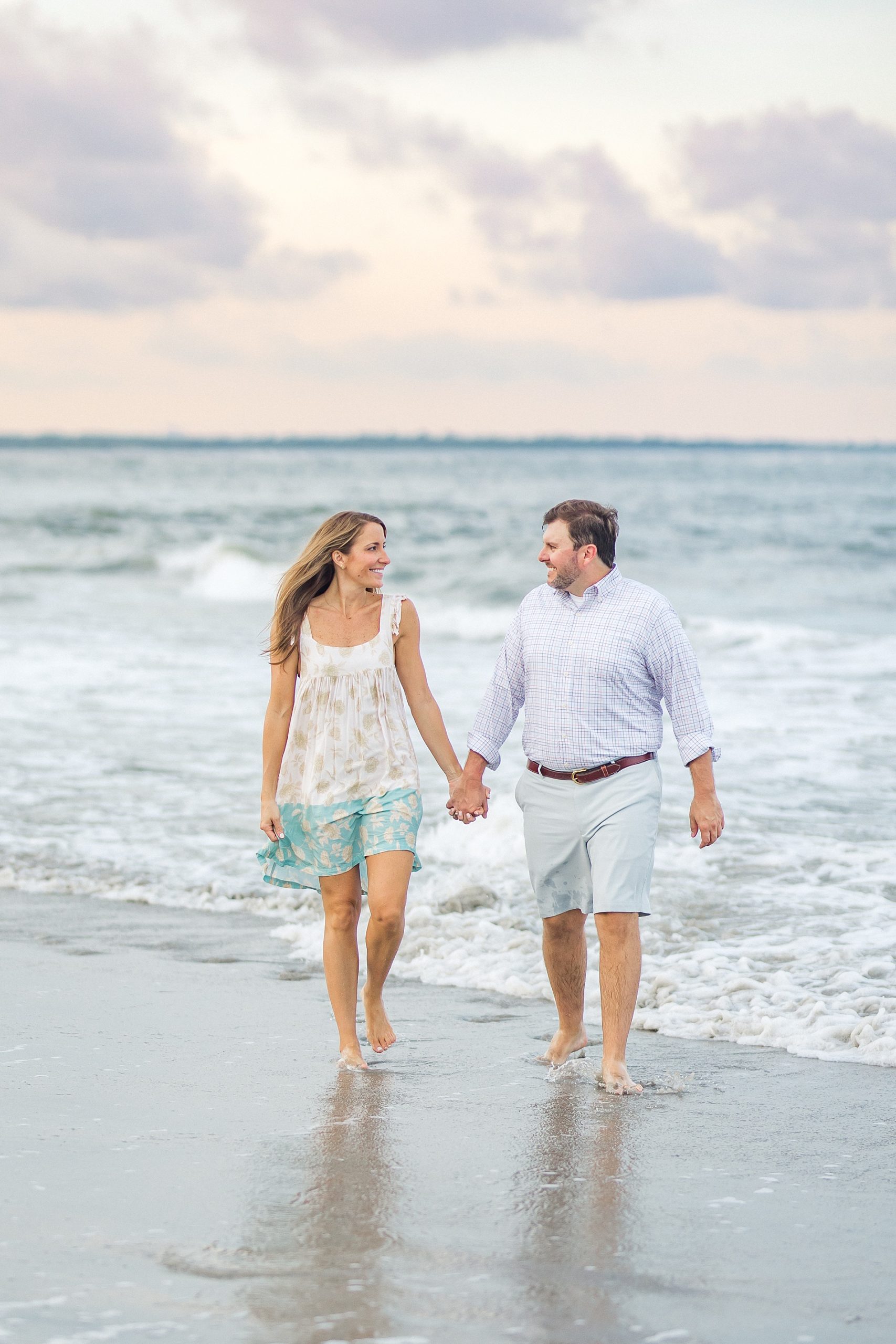 couple hold hands walking in the Ocean
