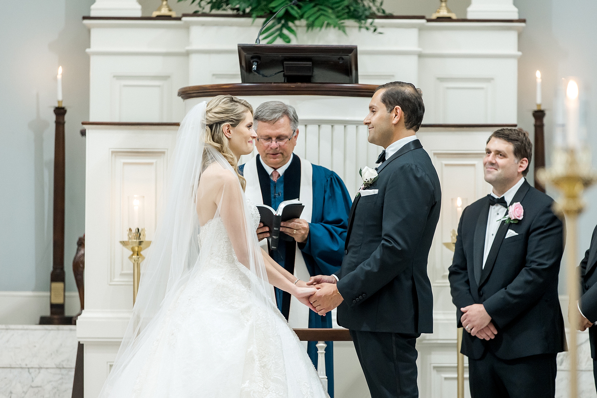 couple exchanging vows during Romantic Charleston Wedding