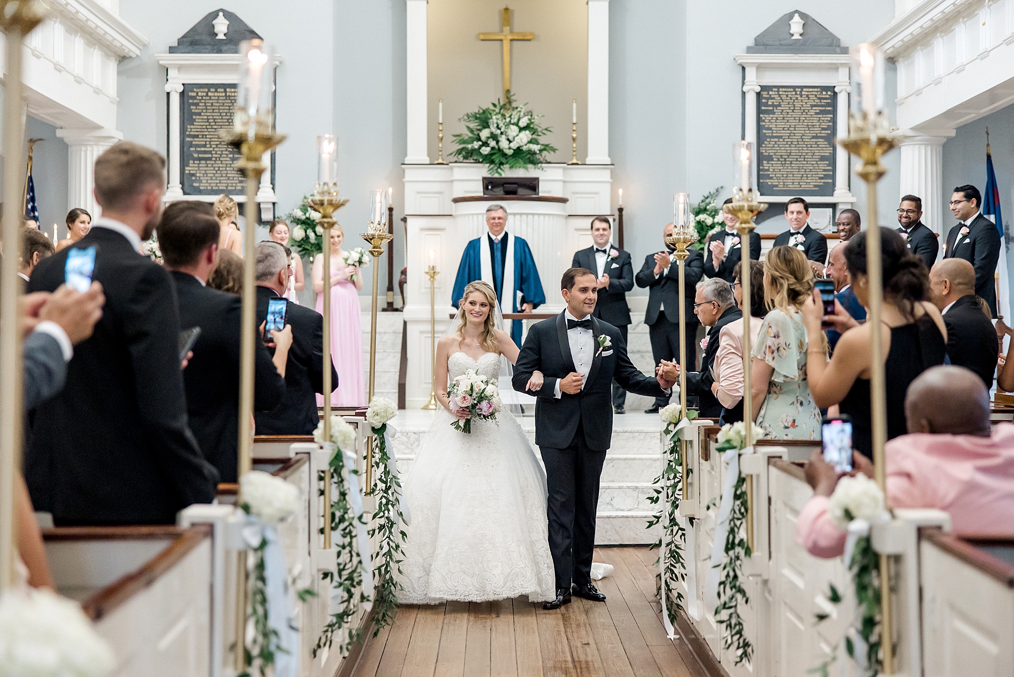 couple walk down the aisle together as husband and wife