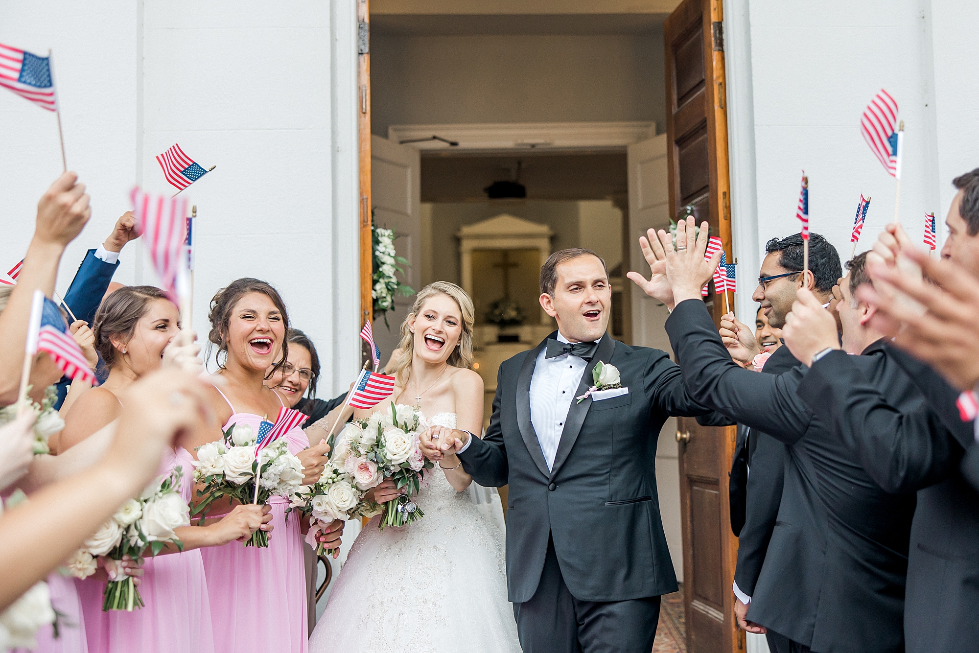 newlyweds celebrate exiting the church as a married couple